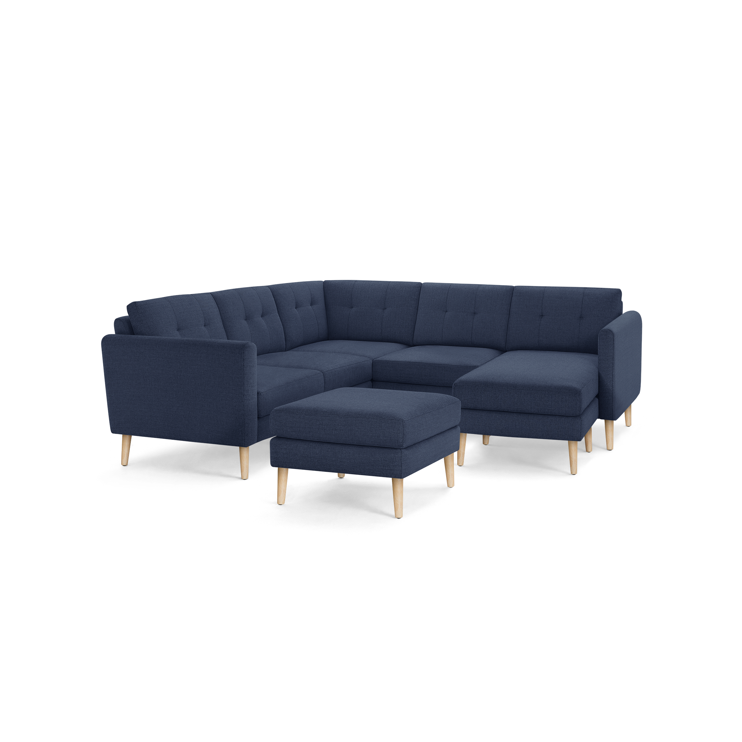 Navy blue L-shaped sectional sofa with tufted cushions, wooden legs, and a matching square ottoman.