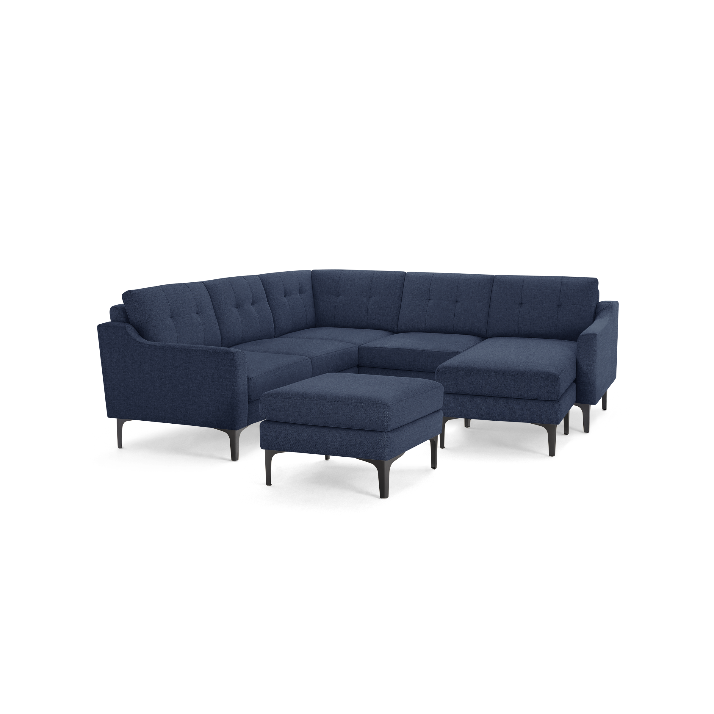 Large modern navy blue fabric sectional sofa with tufted cushions and matching ottoman on black legs.