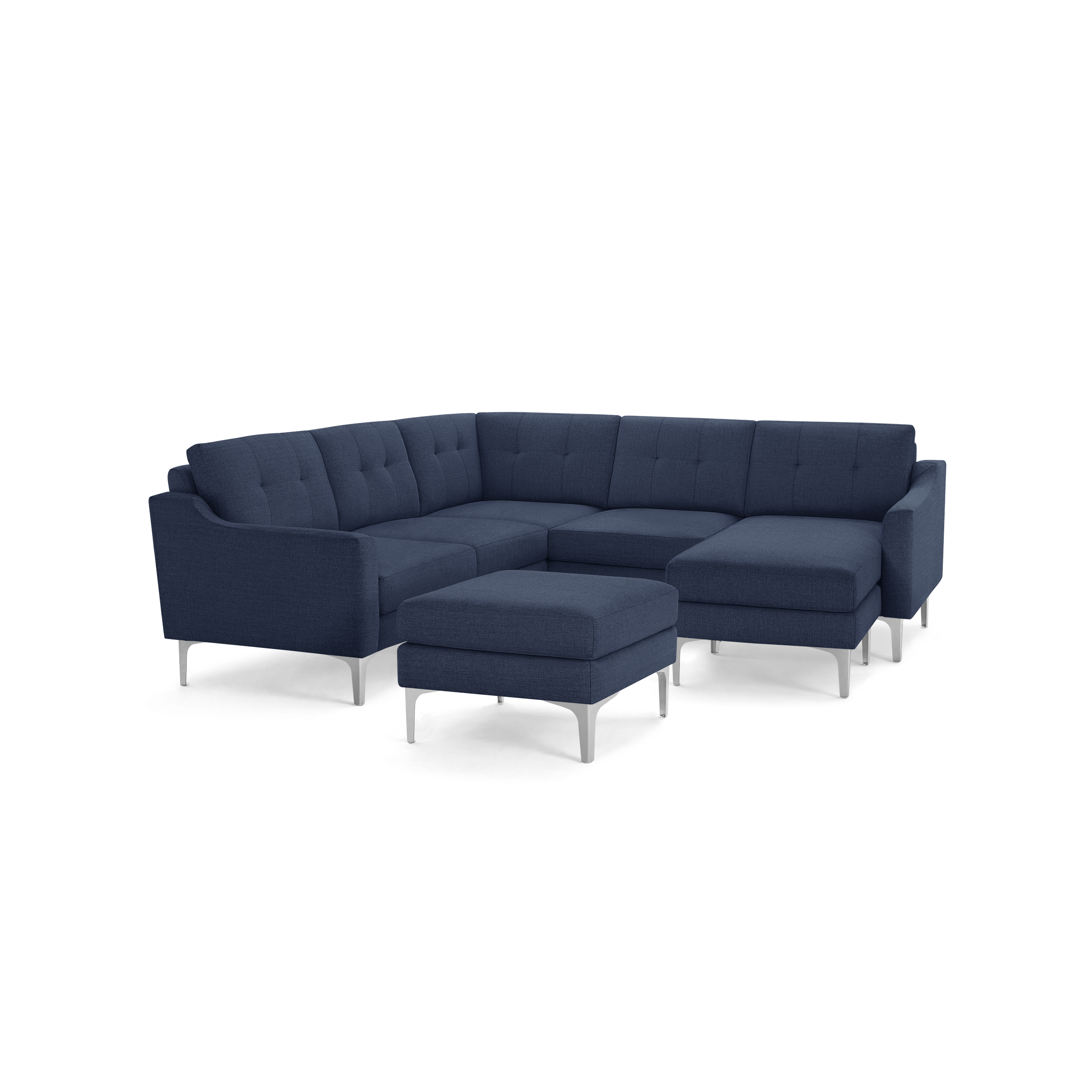 Modern navy blue sectional sofa with tufted back cushions, metal legs, and a matching ottoman on a black background.