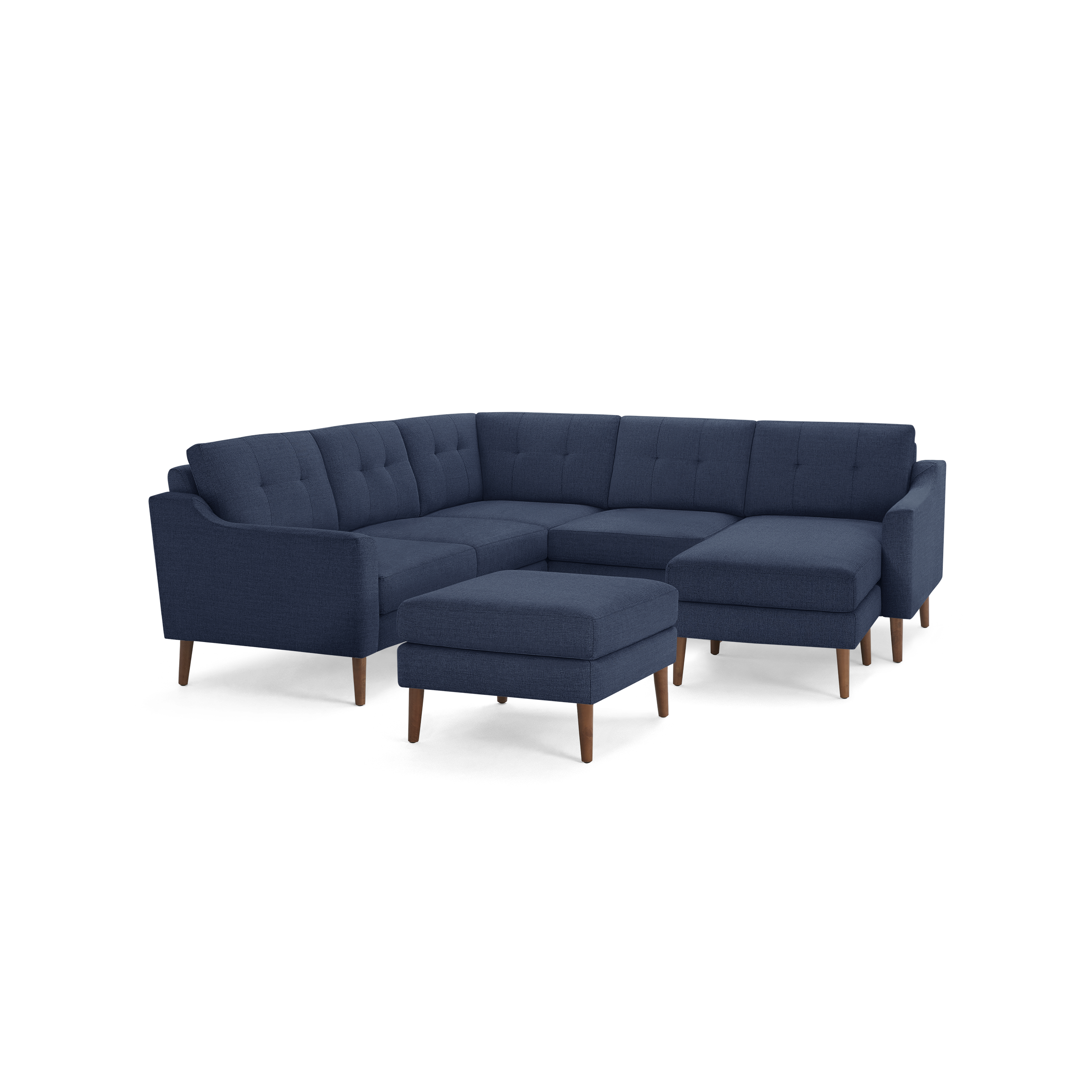 Mid-century modern navy blue fabric sectional sofa with tufted cushions, wooden legs, and a matching ottoman.
