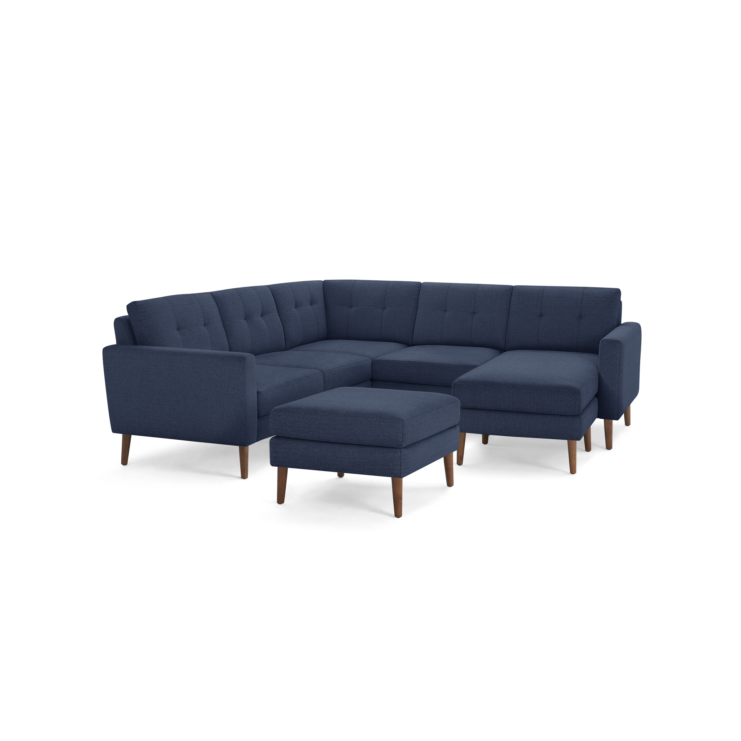 Navy blue L-shaped sectional sofa with tufted back cushions, wooden legs, and a matching upholstered ottoman.