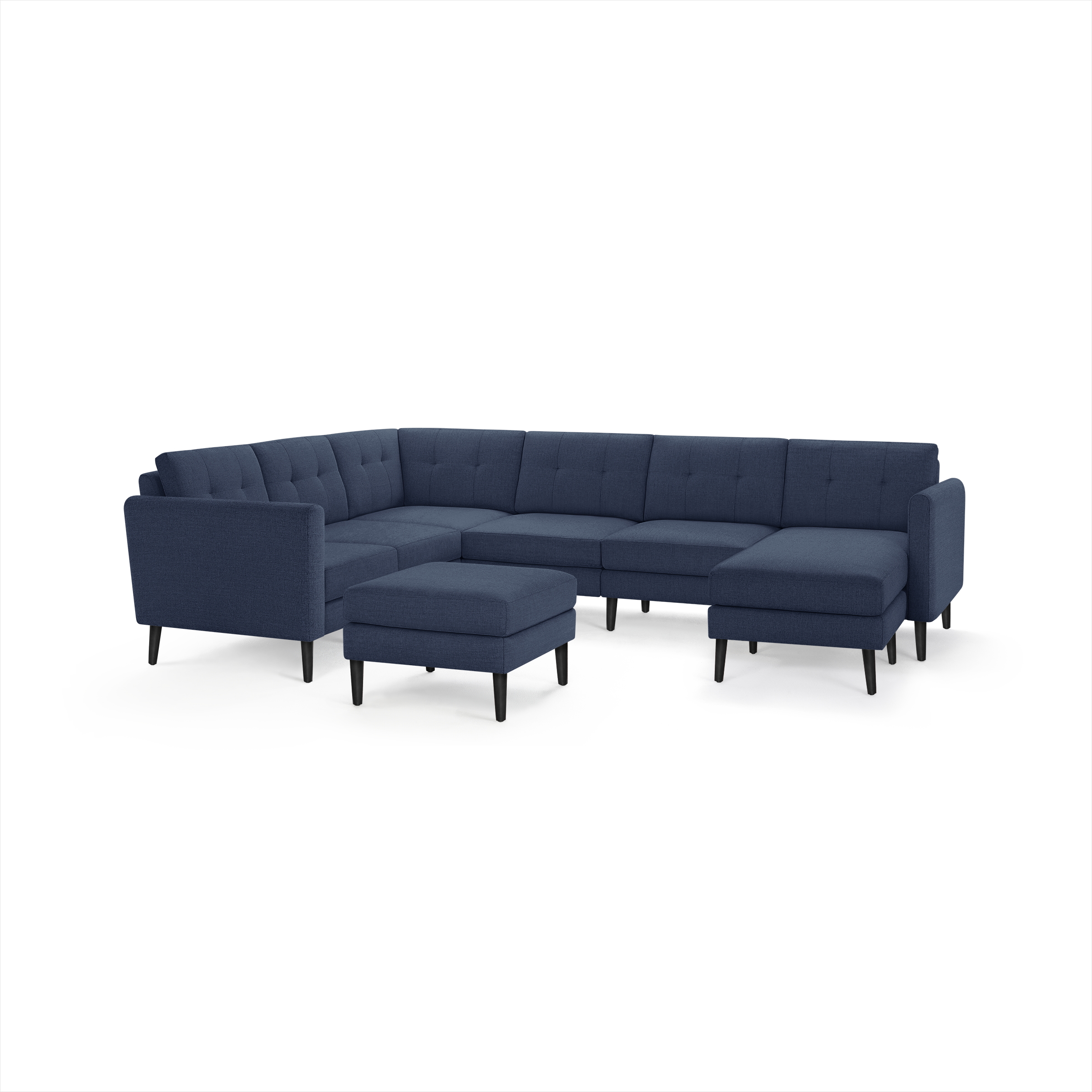 Navy blue L-shaped sectional sofa with tufted cushions, slim black legs, and a matching ottoman on a white background.