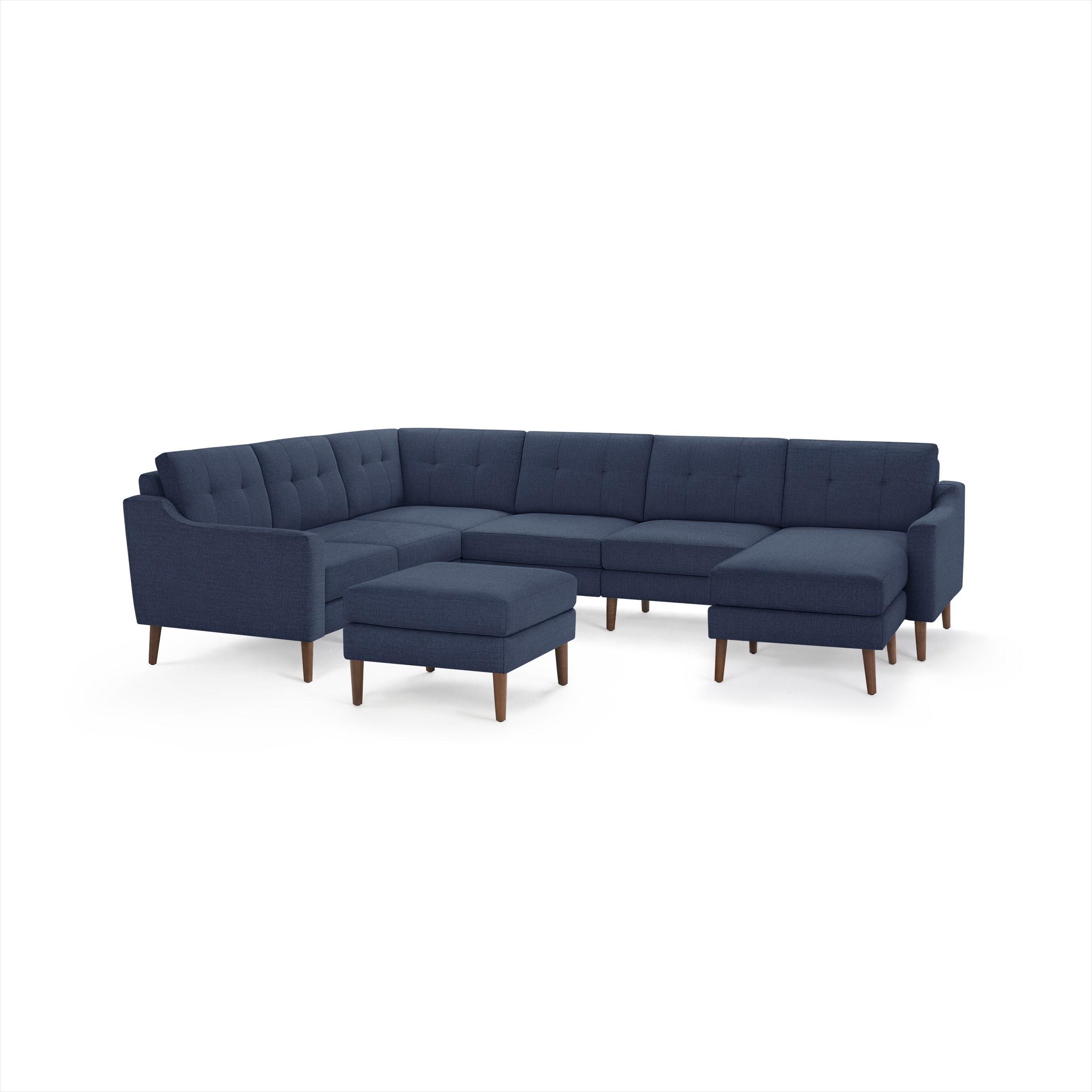 Modern navy blue fabric sectional sofa with tufted cushions, wooden legs, and matching ottoman, designed for spacious seating.