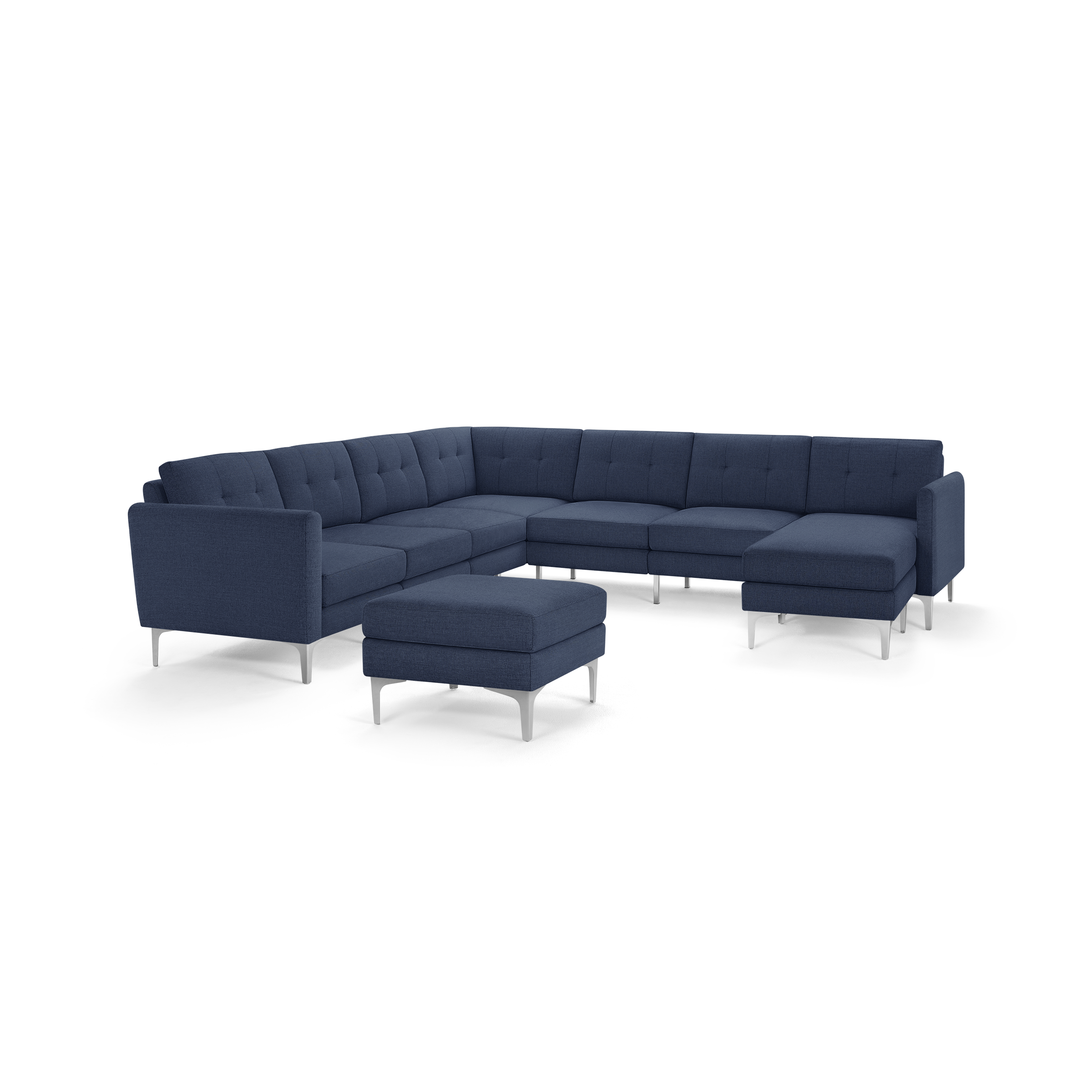Modern navy blue fabric sectional sofa with tufted back cushions and matching ottoman, supported by sleek silver legs.