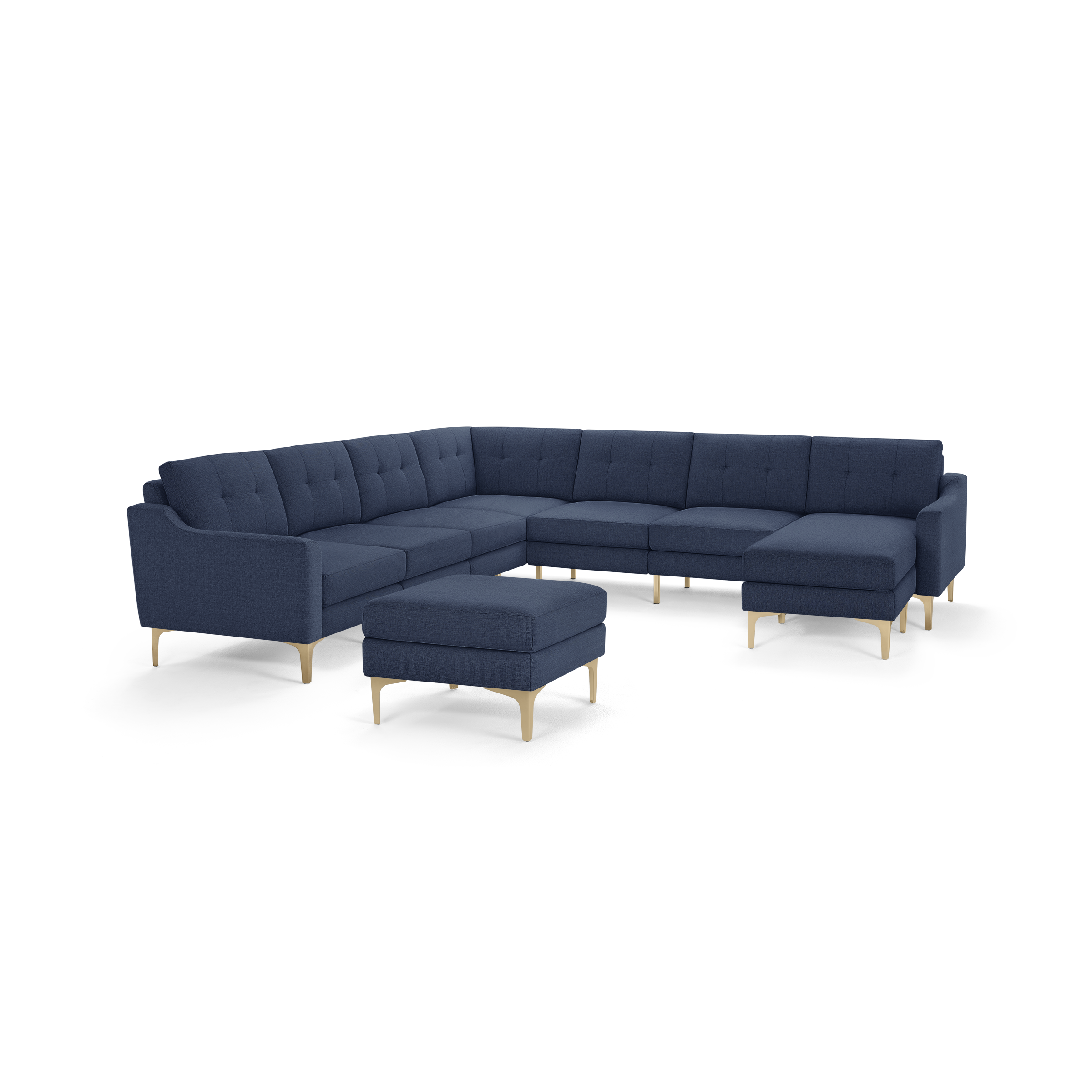 Modern navy blue L-shaped sectional sofa with tufted back cushions, light wooden legs, and matching ottoman on a white background.