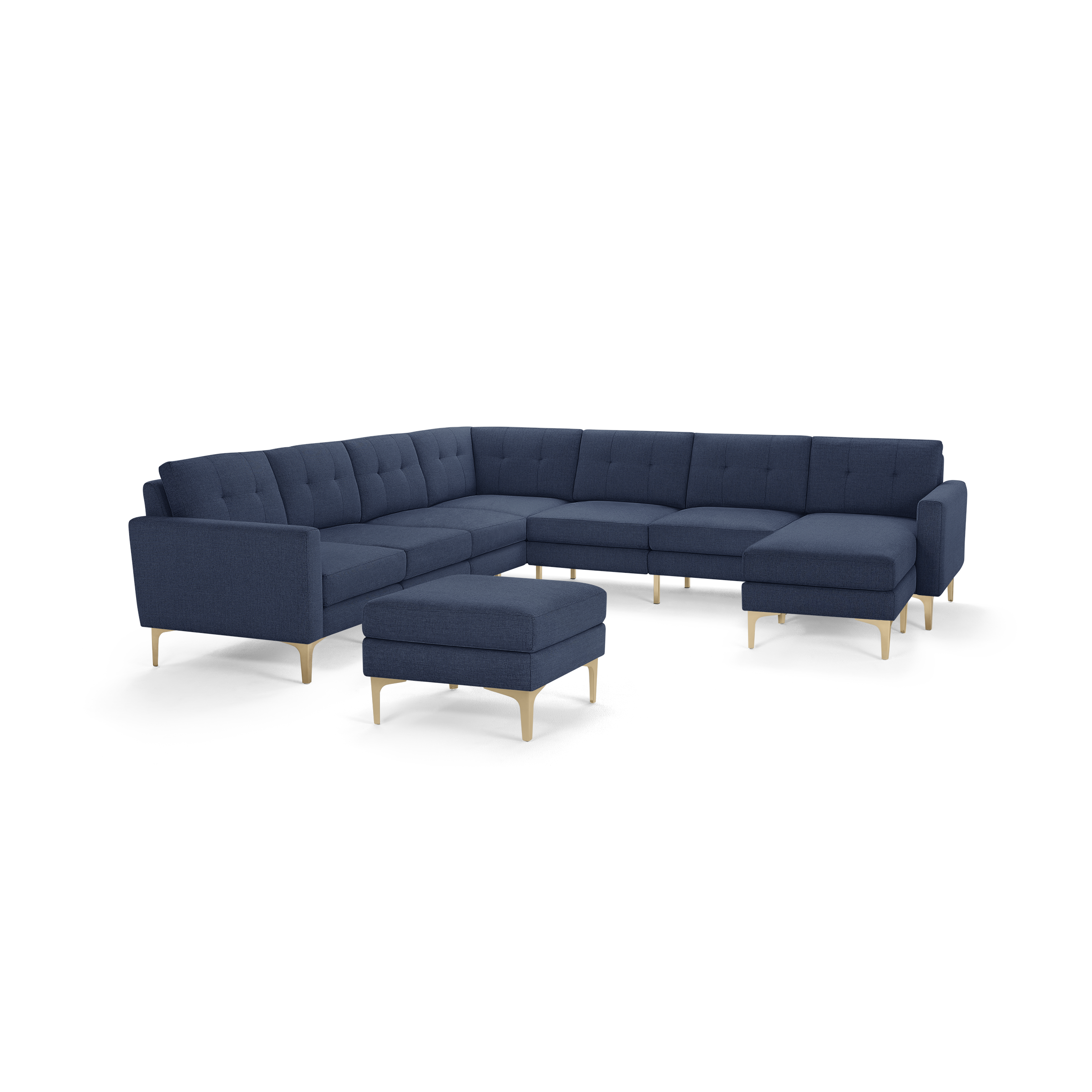 Modern navy blue sectional sofa with tufted cushions, light wooden legs, and matching ottoman, designed for spacious living rooms.