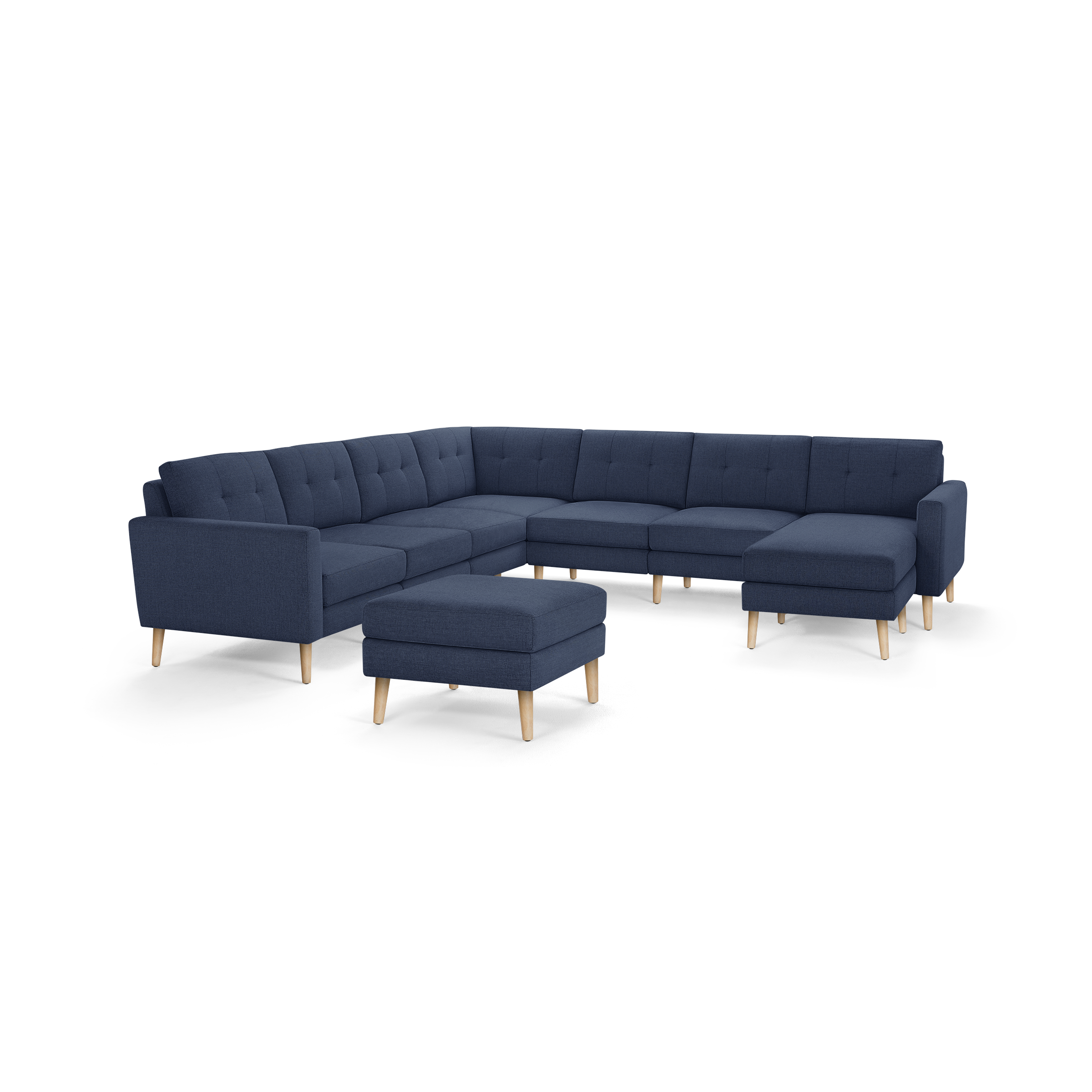 L-shaped modern sectional sofa with navy blue fabric upholstery, button tufting, wooden legs, and matching ottoman.