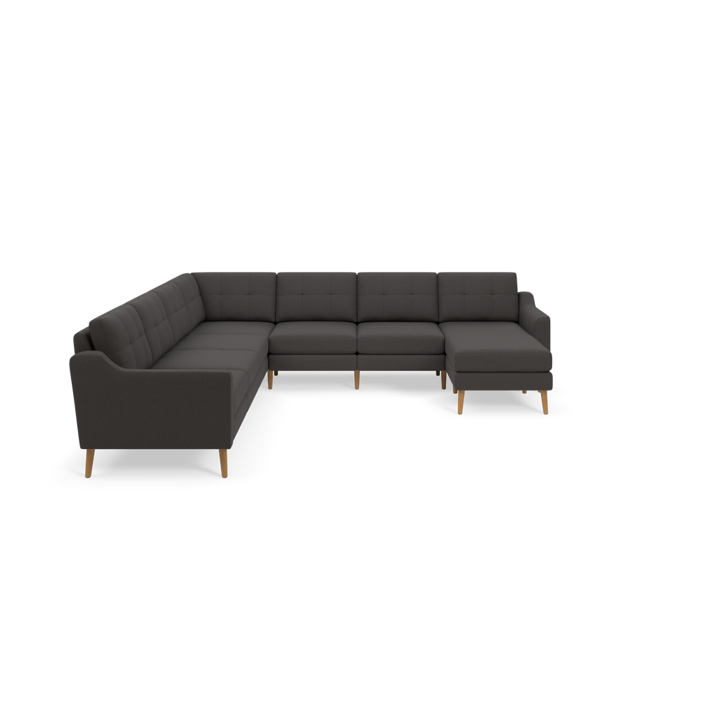 Large modern L-shaped sectional sofa with dark gray tufted cushions and wooden legs, featuring a right-side chaise lounge.