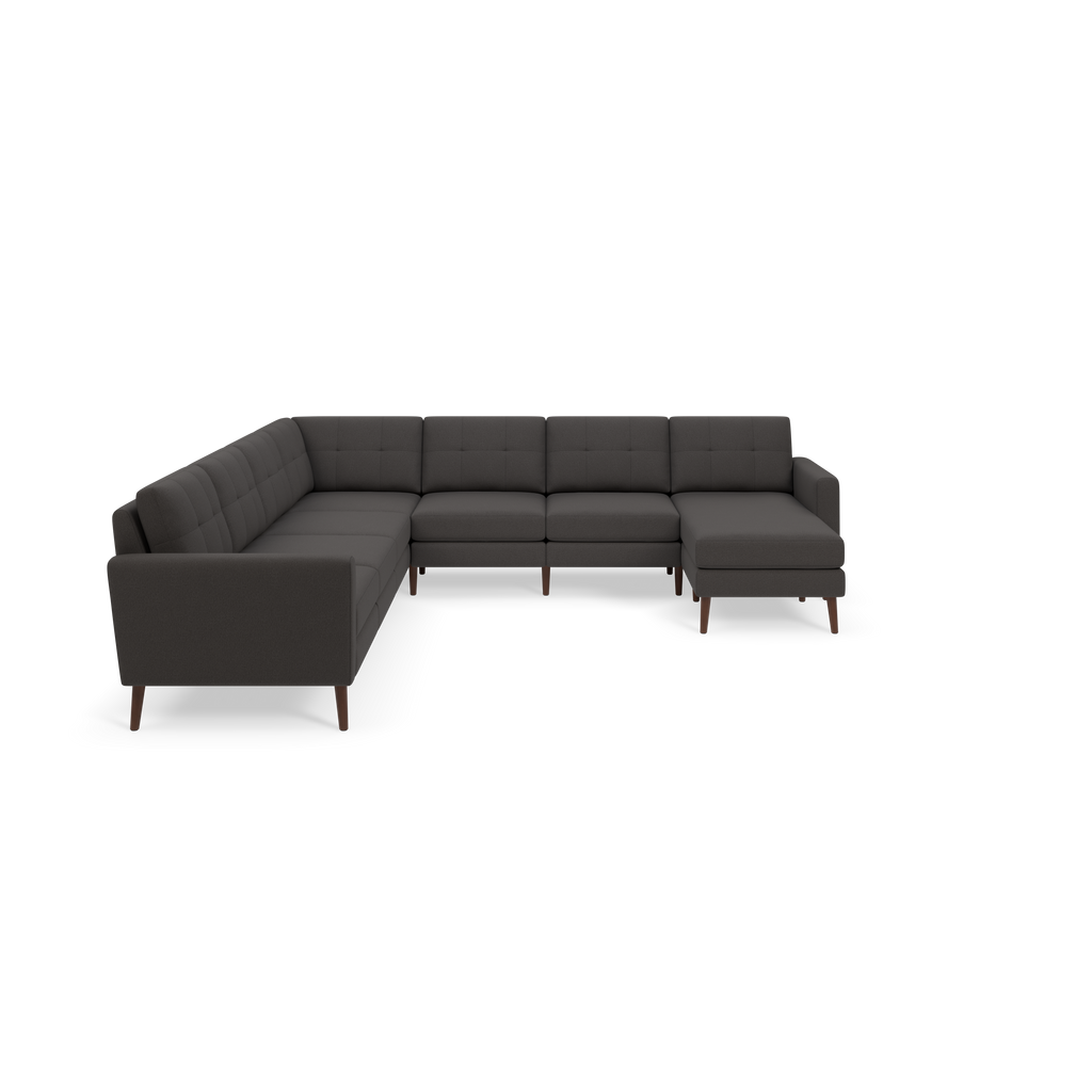Dark gray L-shaped sectional sofa with tufted cushions, wooden legs, and a chaise lounge on the right side.