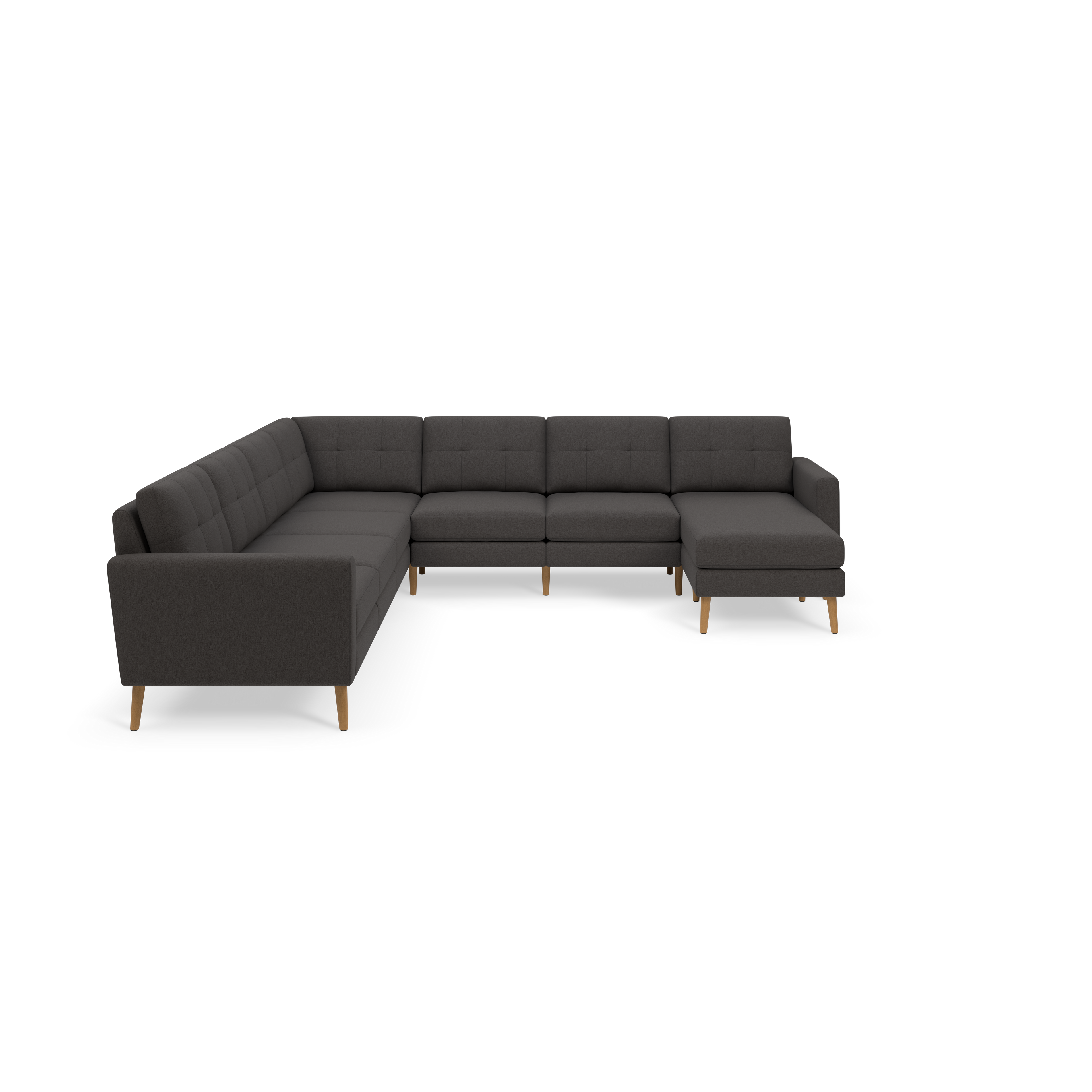 Dark gray L-shaped sectional sofa with tufted cushions and light wooden legs, set against black background.