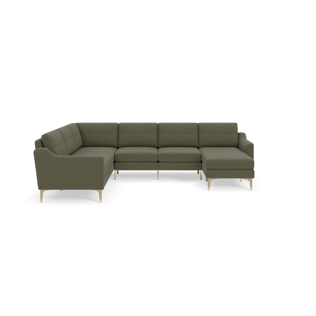 Modern L-shaped sectional sofa in muted Moss green fabric with tufted cushions and slim light wooden legs on black background.