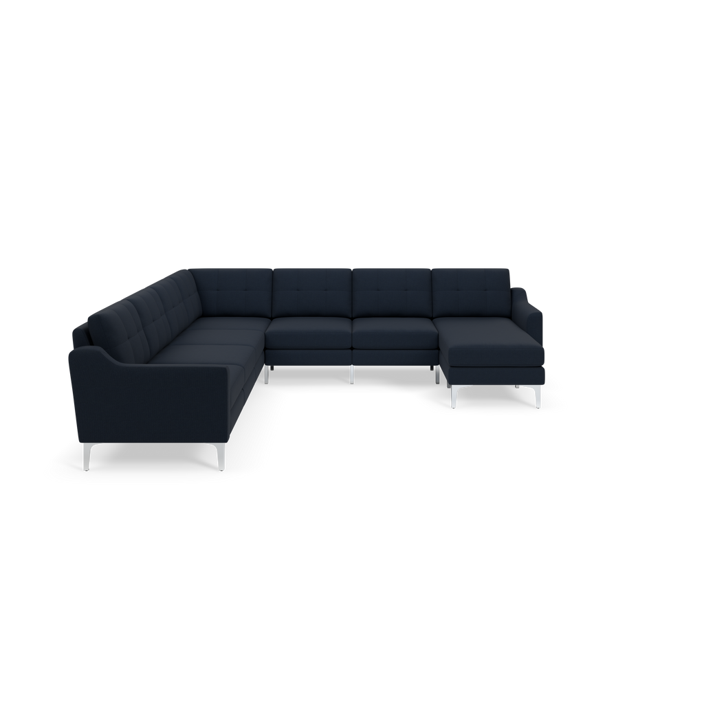 L-shaped sectional sofa in dark navy blue fabric with tufted cushions and sleek metal legs, modern design.