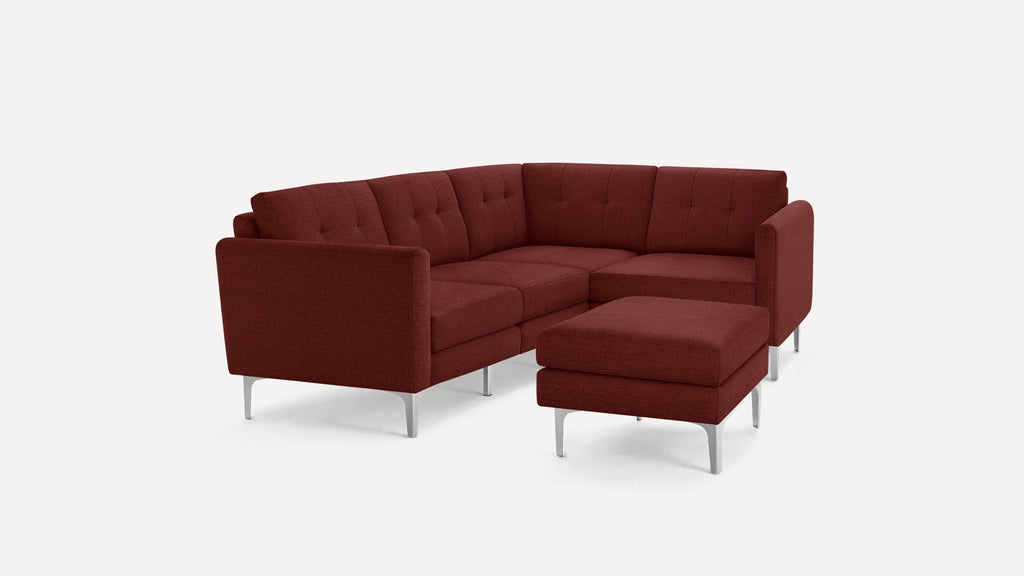 Modern rust-colored sectional sofa with tufted cushions, metal legs, and a matching ottoman on a white background.