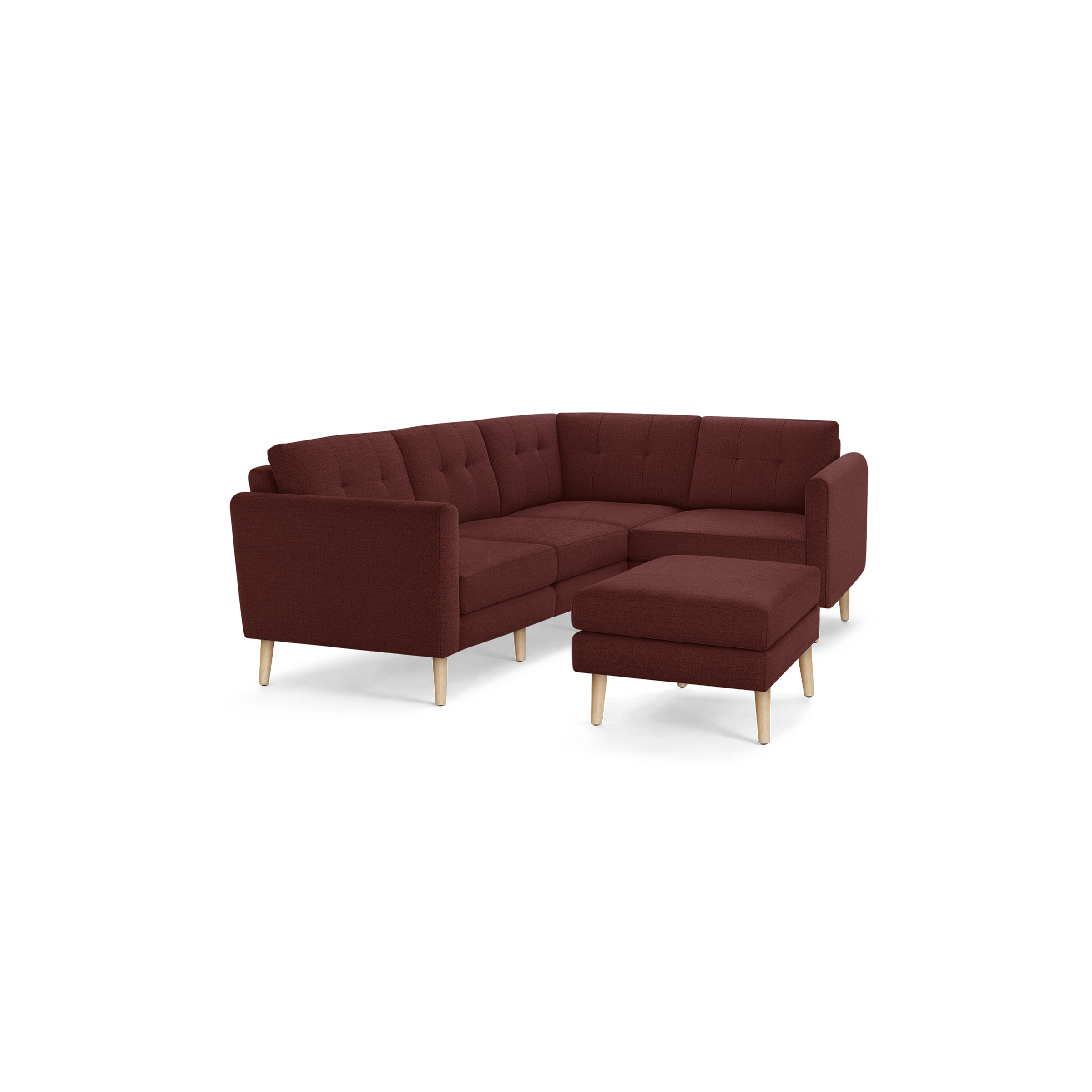 Modern L-shaped sectional sofa in deep red fabric with tufted cushions and light wooden legs, including a matching ottoman.