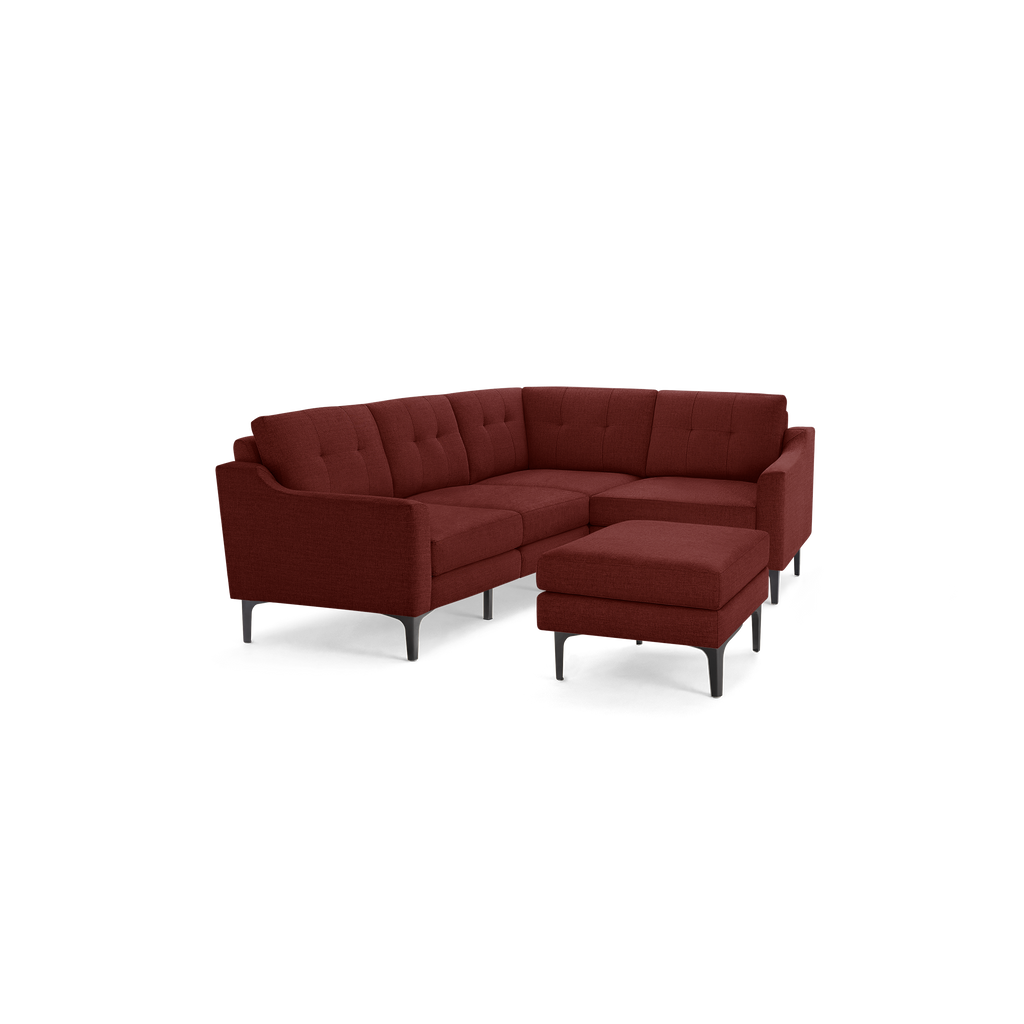Modern L-shaped sectional sofa in deep red fabric with tufted cushions and black angled metal legs, including matching ottoman.