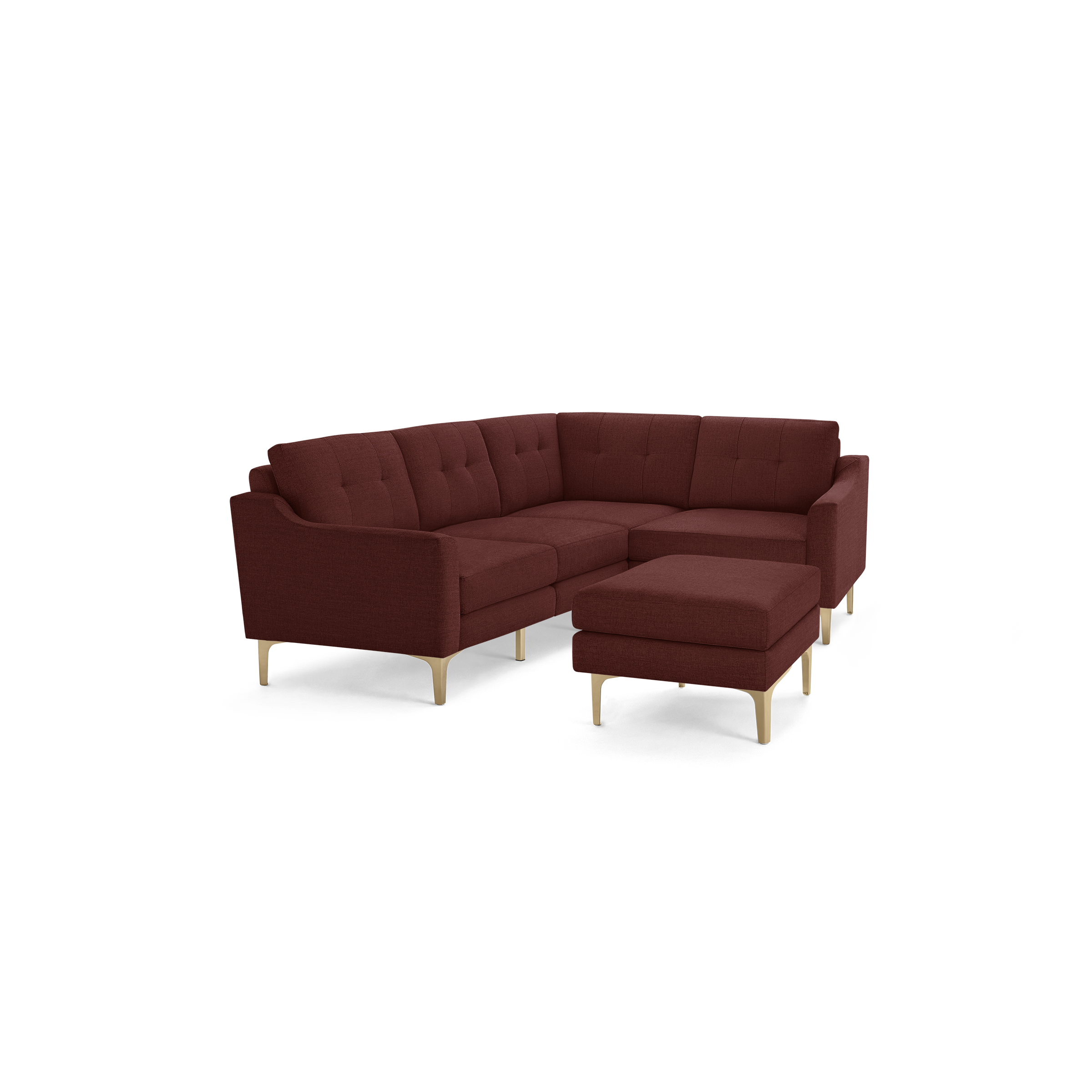 Modern L-shaped sectional sofa in deep red fabric with tufted cushions and light wooden legs, accompanied by a matching ottoman.