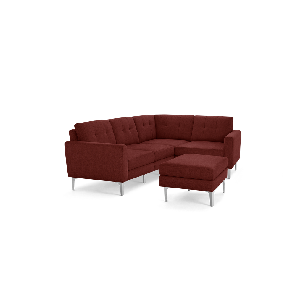 Modern L-shaped sectional sofa and matching ottoman in deep reddish-brown fabric, featuring tufted cushions and silver metal legs.