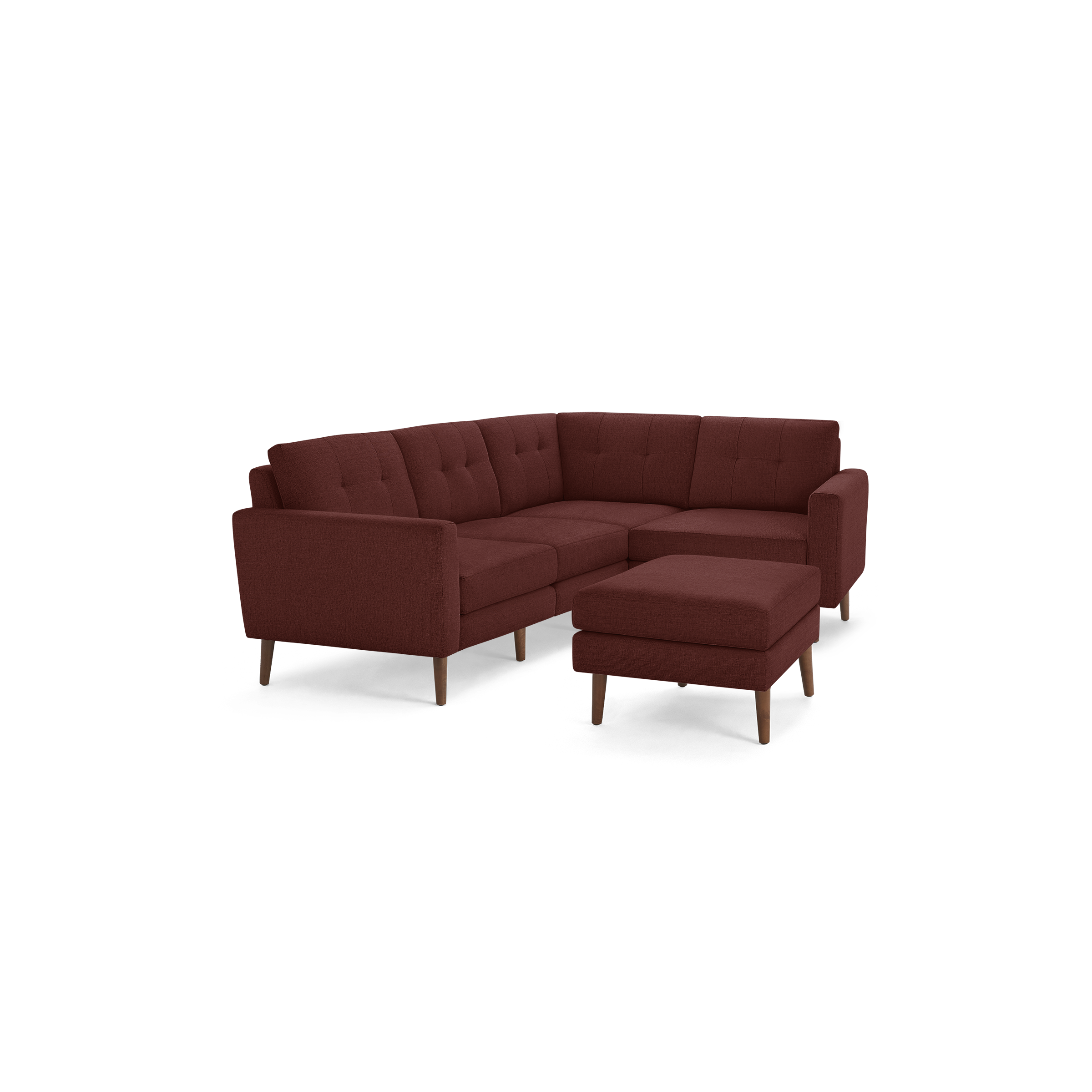 Mid-century style sectional sofa in deep red fabric with tufted back cushions and matching ottoman, supported by wooden legs.