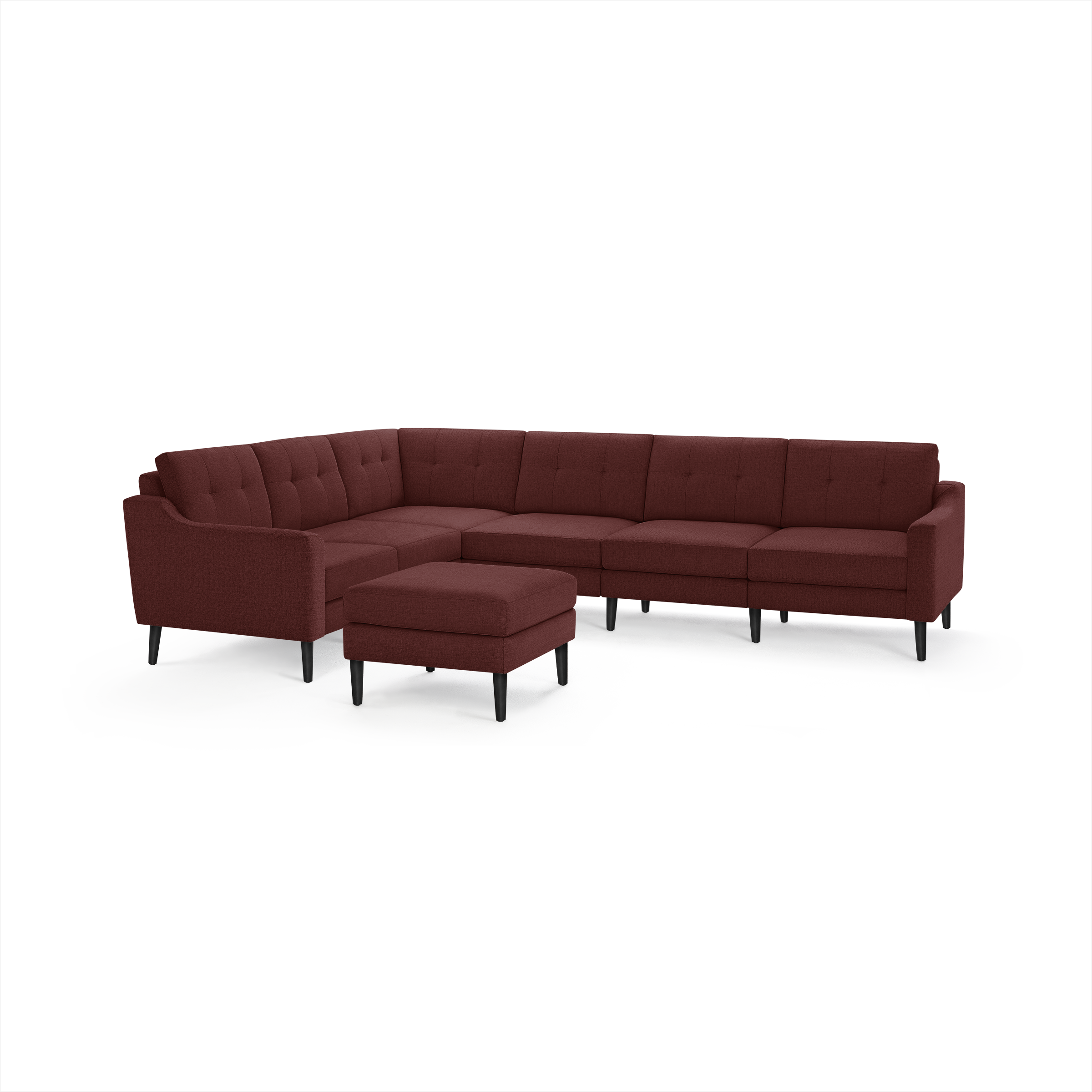 L-shaped sectional sofa in deep red fabric with tufted cushions, black tapered legs, and a matching ottoman.