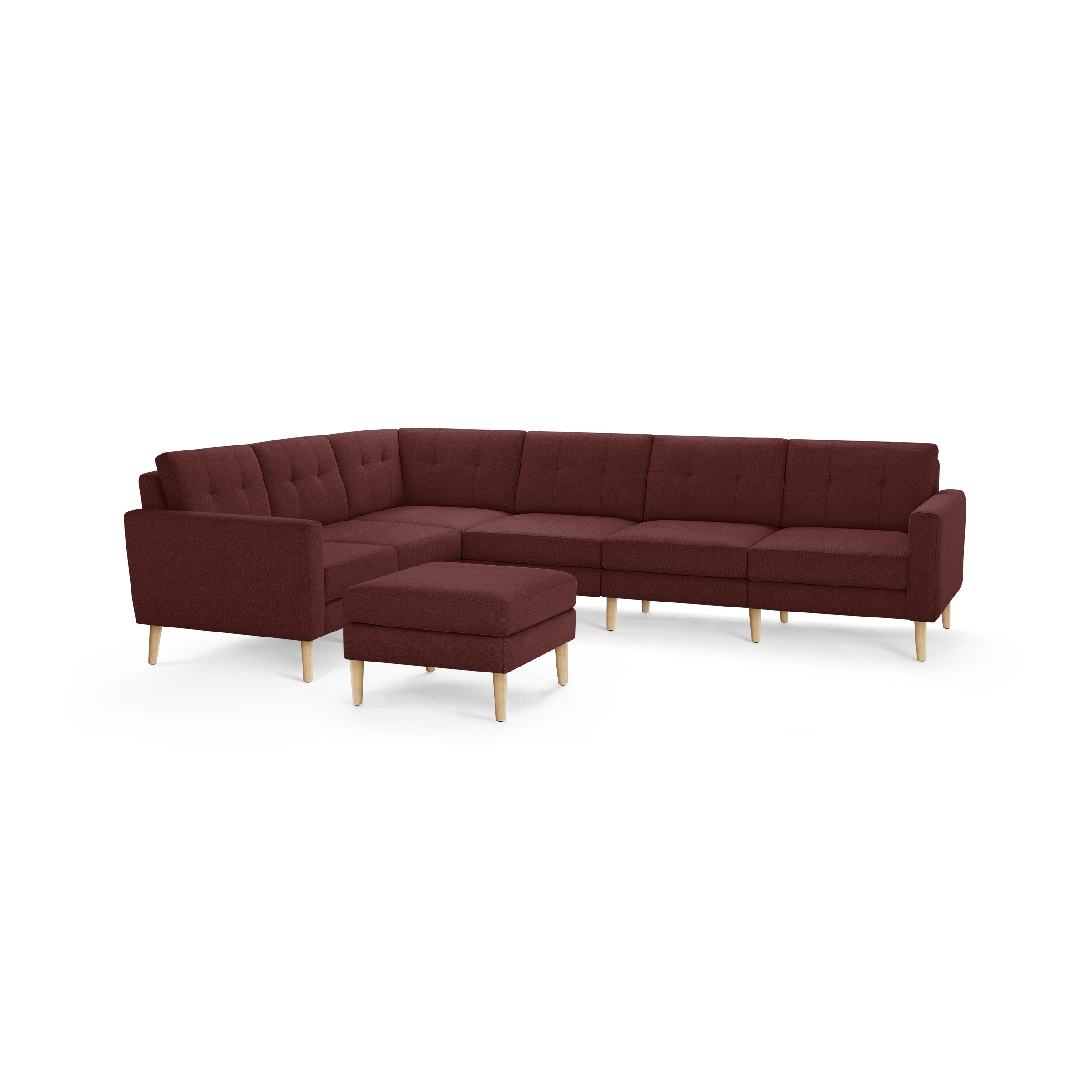 Mid-century style large L-shaped sectional sofa with tufted red upholstery and light wooden legs, including a matching ottoman.