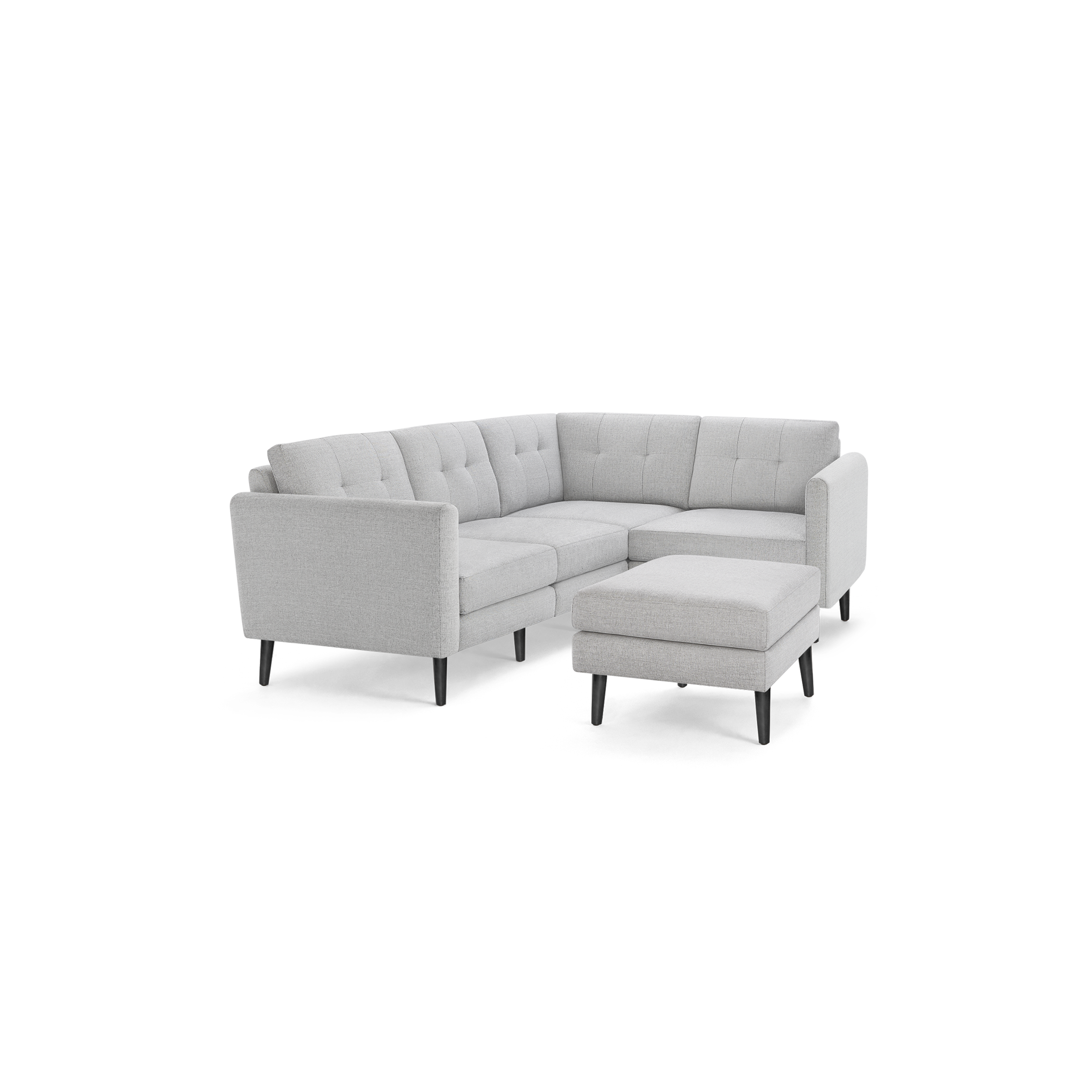 Light gray fabric L-shaped sectional sofa with tufted back cushions and matching ottoman, supported by dark wooden legs.
