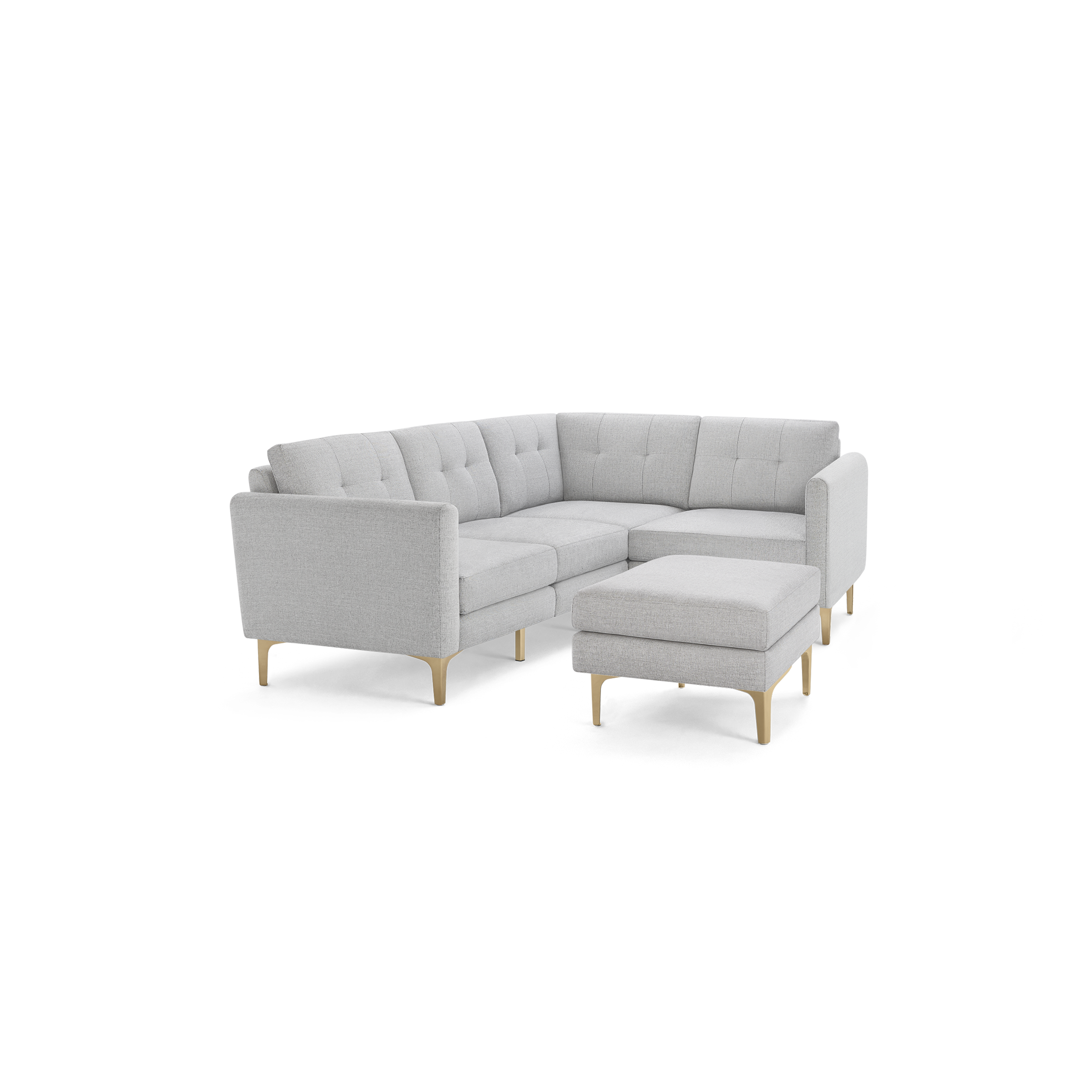 Light gray L-shaped sectional sofa with tufted back cushions and matching ottoman, supported by light wooden legs.