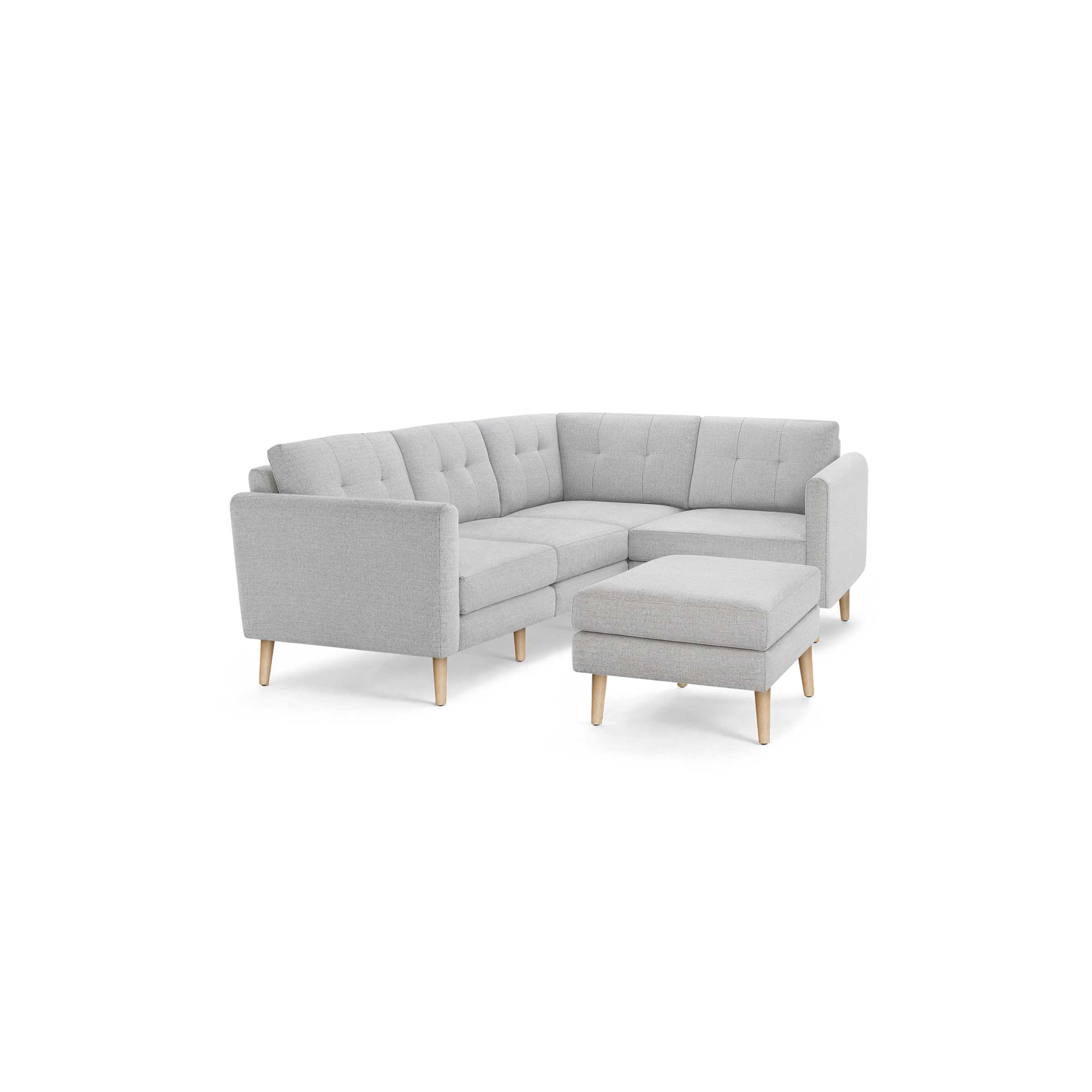 Light gray L-shaped sectional sofa with tufted cushions and matching ottoman, featuring wooden legs.
