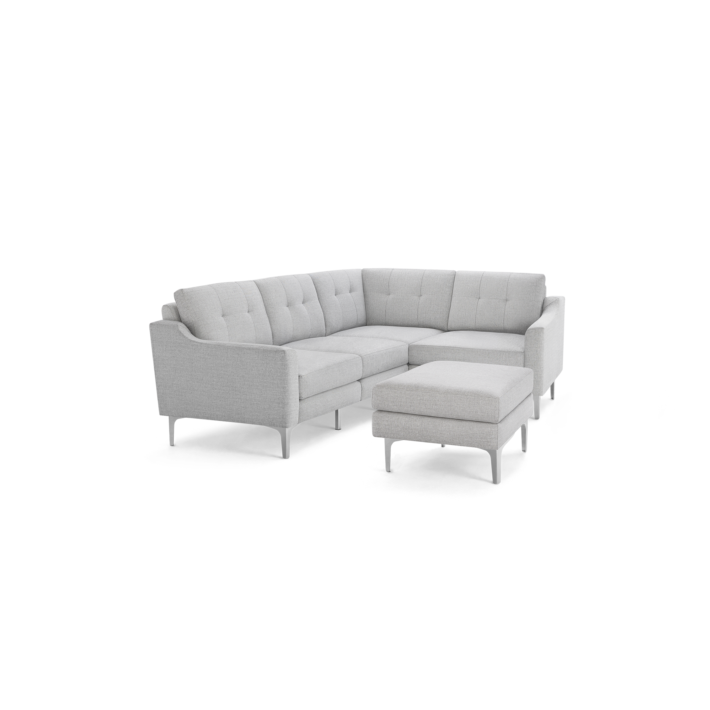 Light gray L-shaped sectional sofa with tufted back cushions and matching ottoman, supported by slender legs.