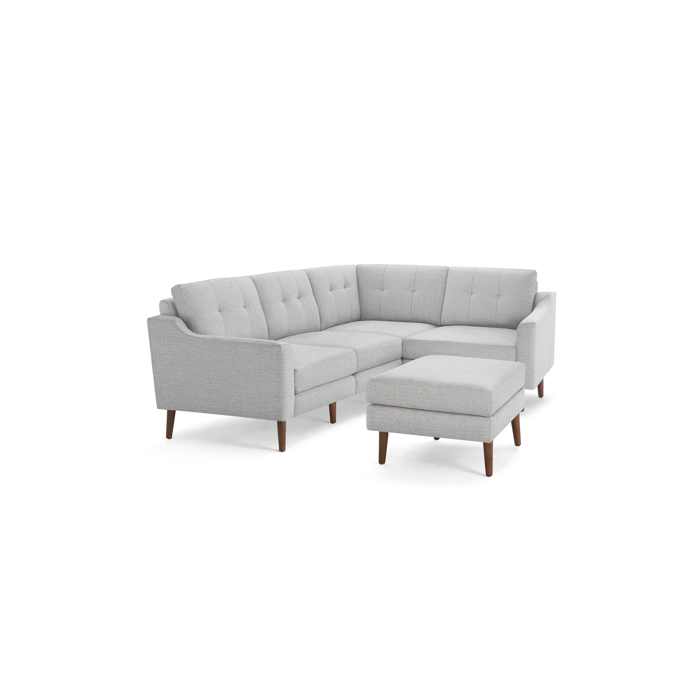 Light gray fabric sectional sofa with tufted cushions, wooden legs, and a matching ottoman, modern design.