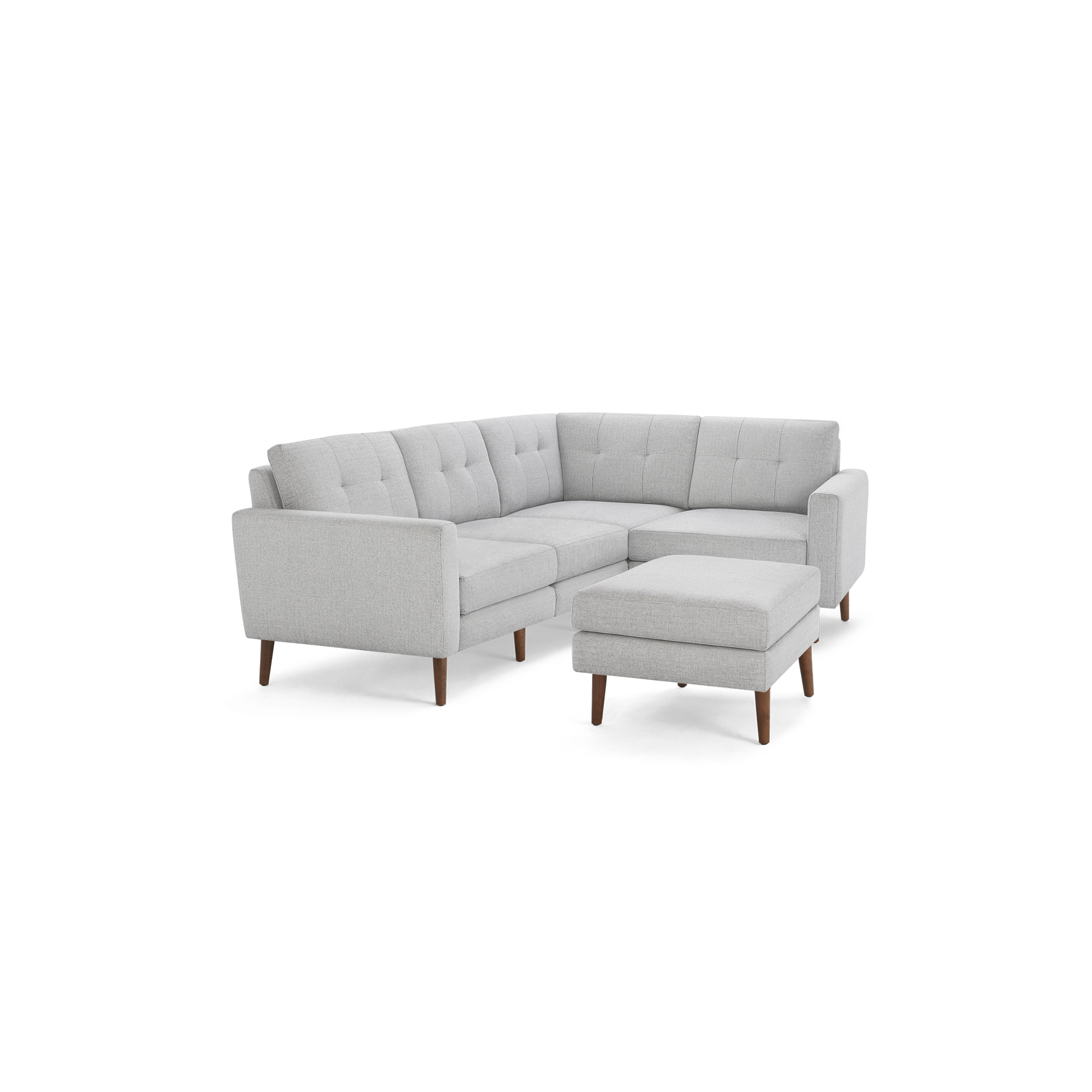 Light gray L-shaped sectional sofa with tufted cushions and wooden legs, accompanied by a matching square ottoman.