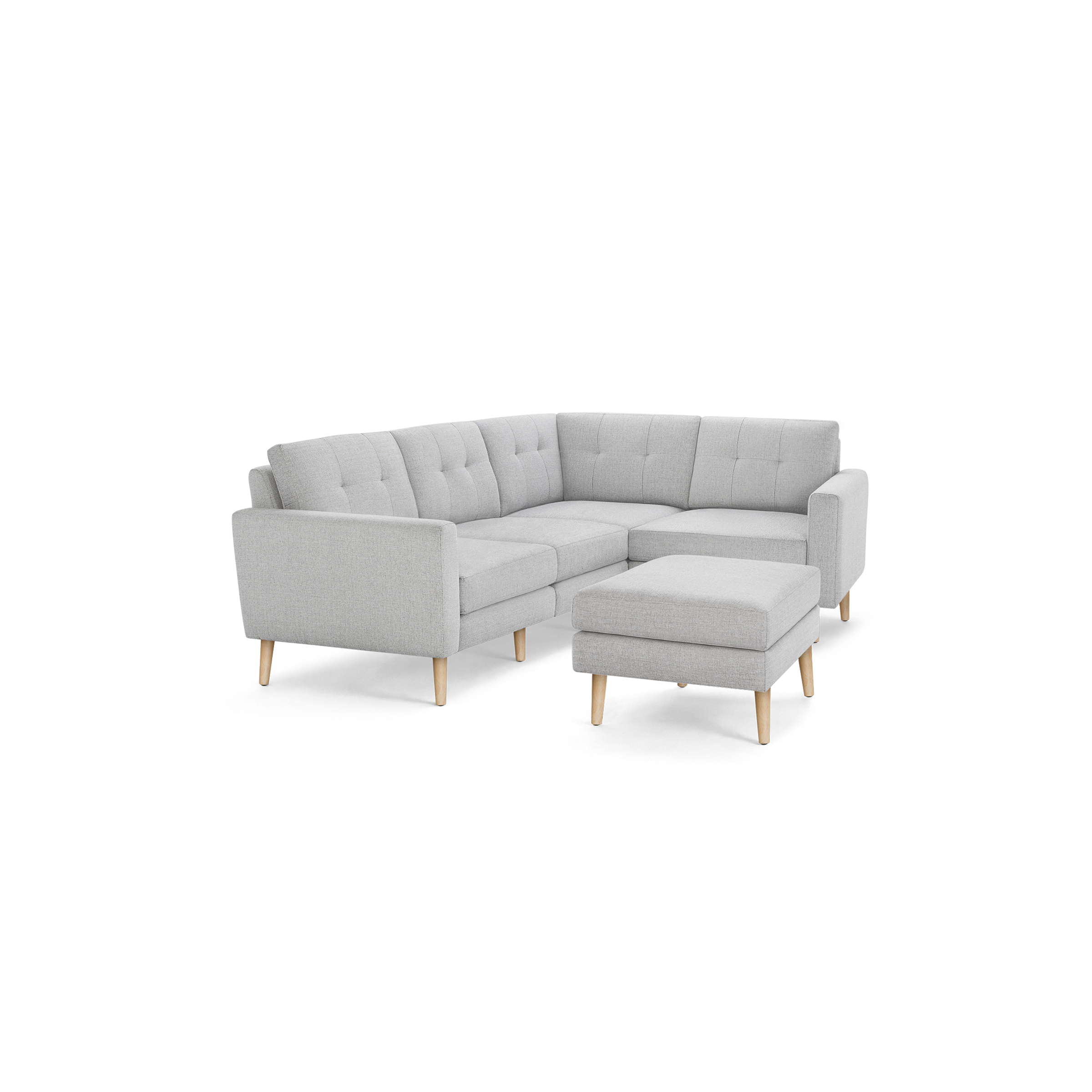 Light gray L-shaped sectional sofa with tufted back cushions and matching ottoman, supported by wooden legs.