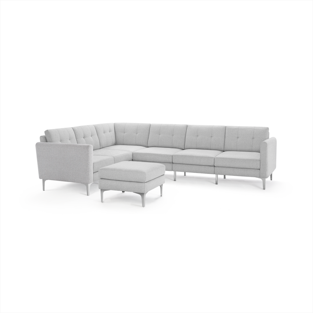 Light gray modern L-shaped sectional sofa with tufted cushions and matching ottoman, supported by slim metal legs.