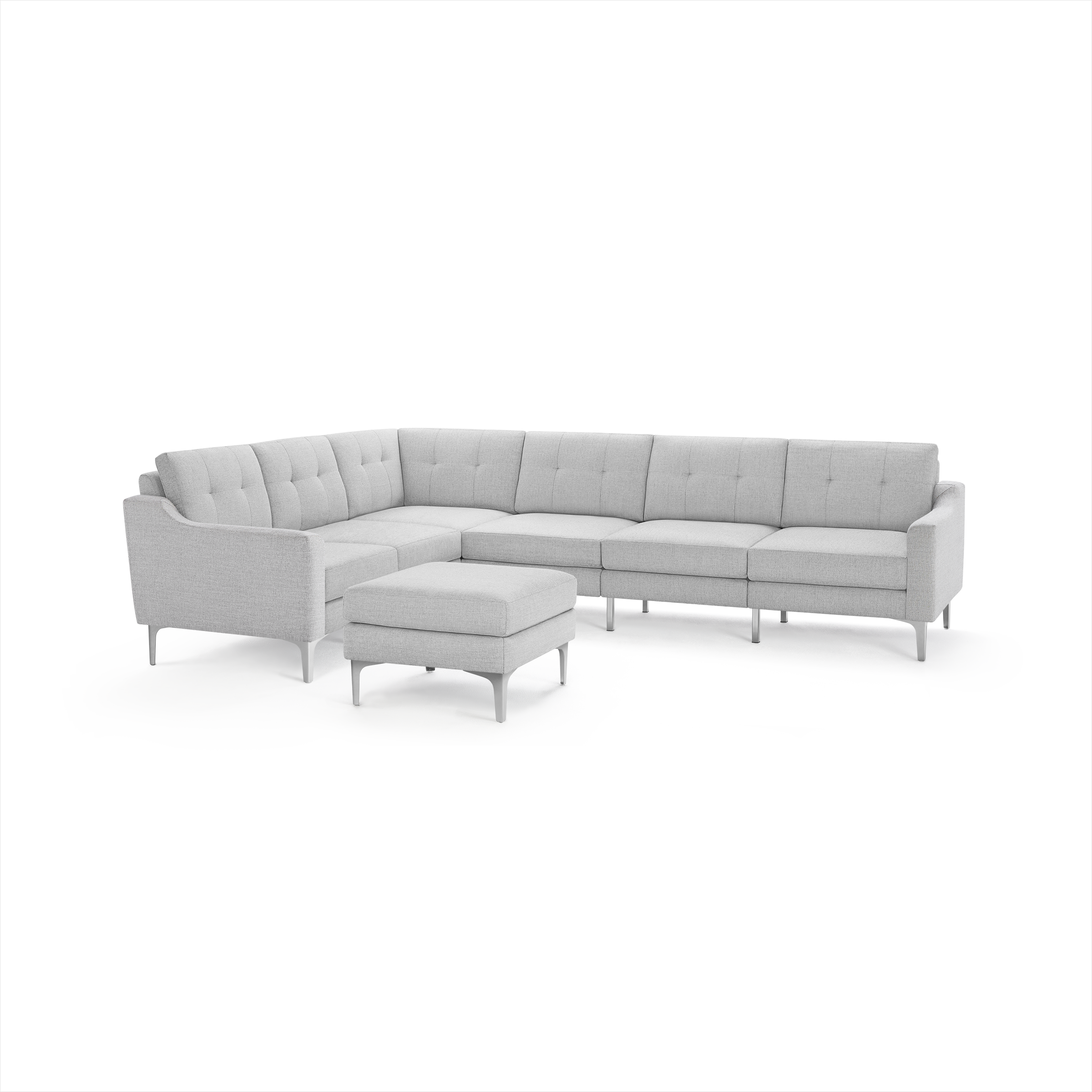 Light gray L-shaped sectional sofa with tufted cushions and metal legs, accompanied by a matching upholstered ottoman.