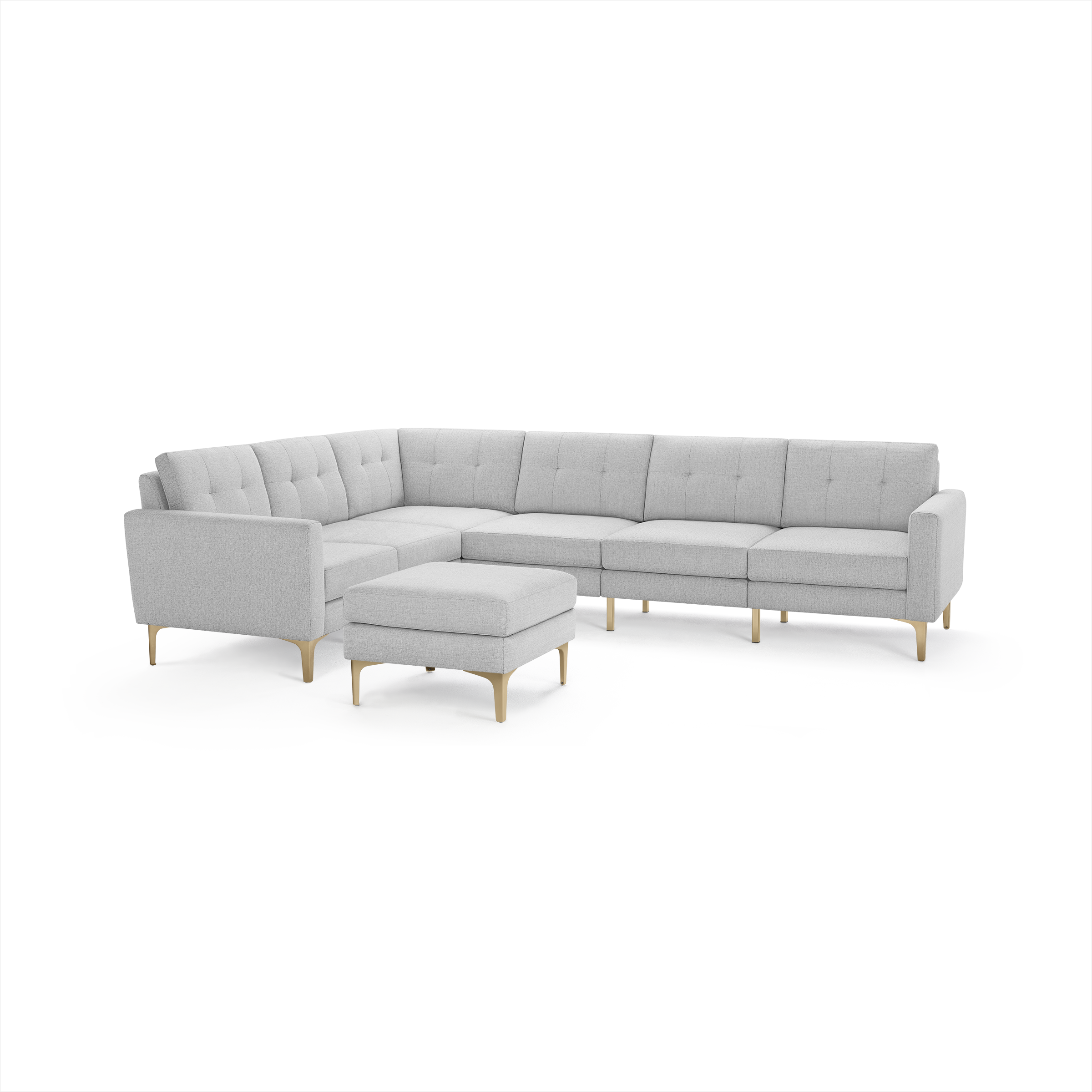 Light gray L-shaped sectional sofa with tufted cushions and wooden legs, accompanied by a matching ottoman.