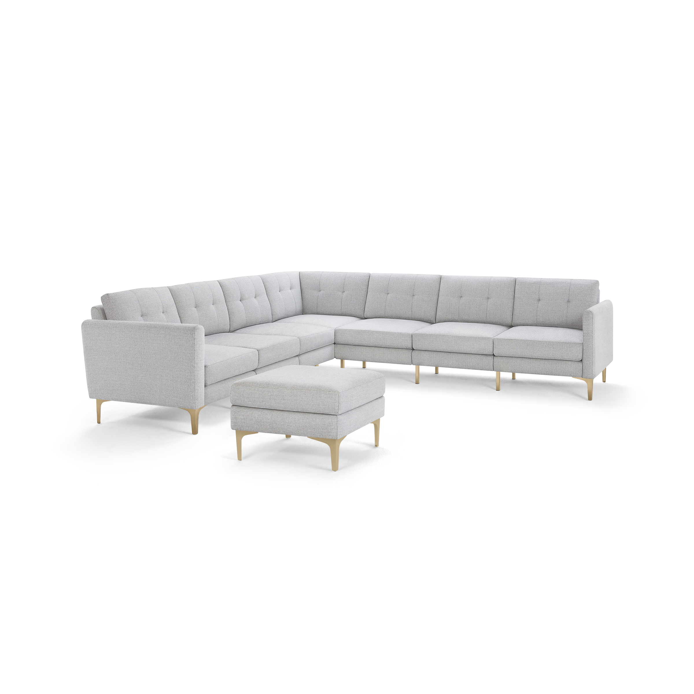 Light gray fabric L-shaped sectional sofa with tufted cushions and wooden legs, accompanied by a matching ottoman.
