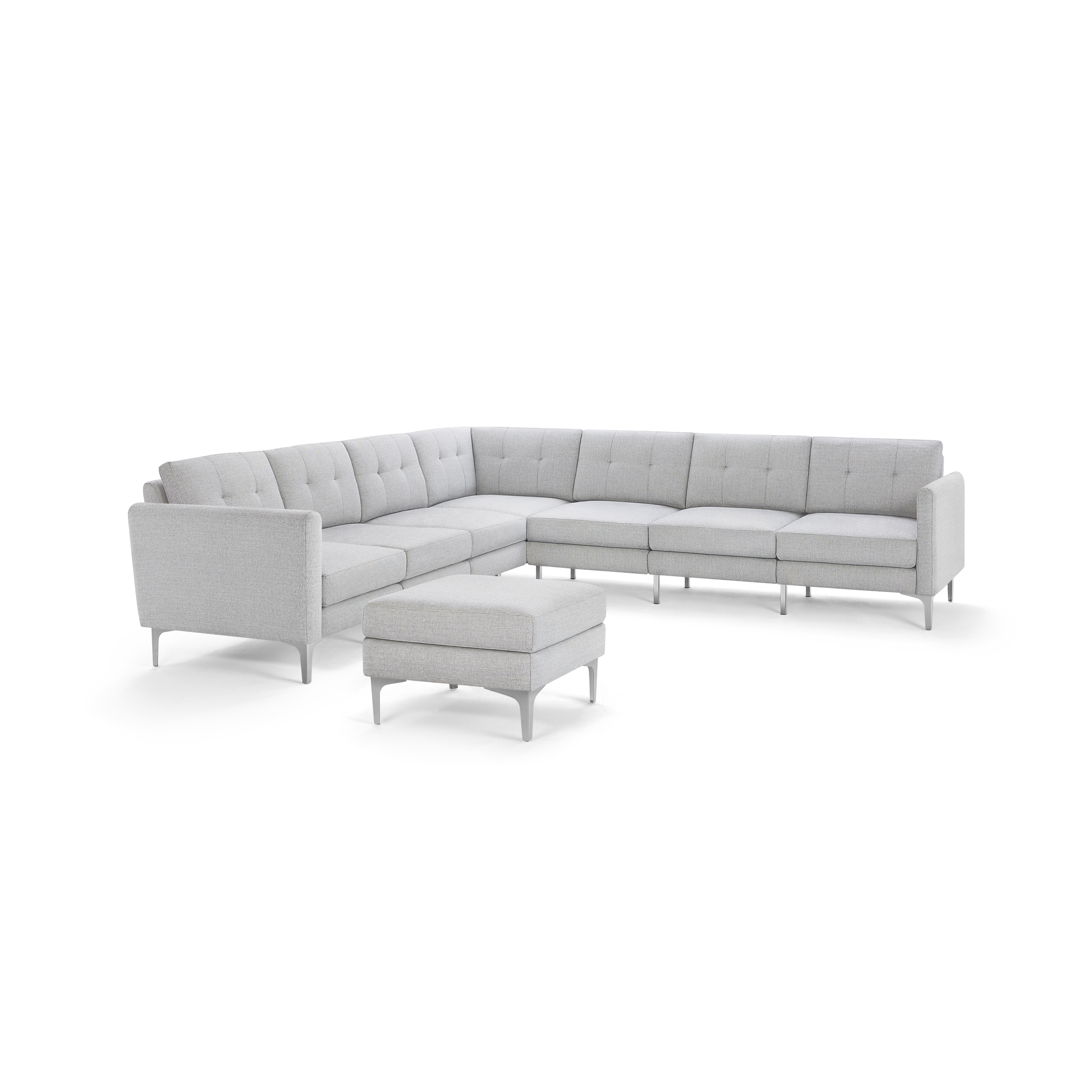 Light gray L-shaped modern sectional sofa with tufted cushions and matching ottoman, supported by slender metal legs.