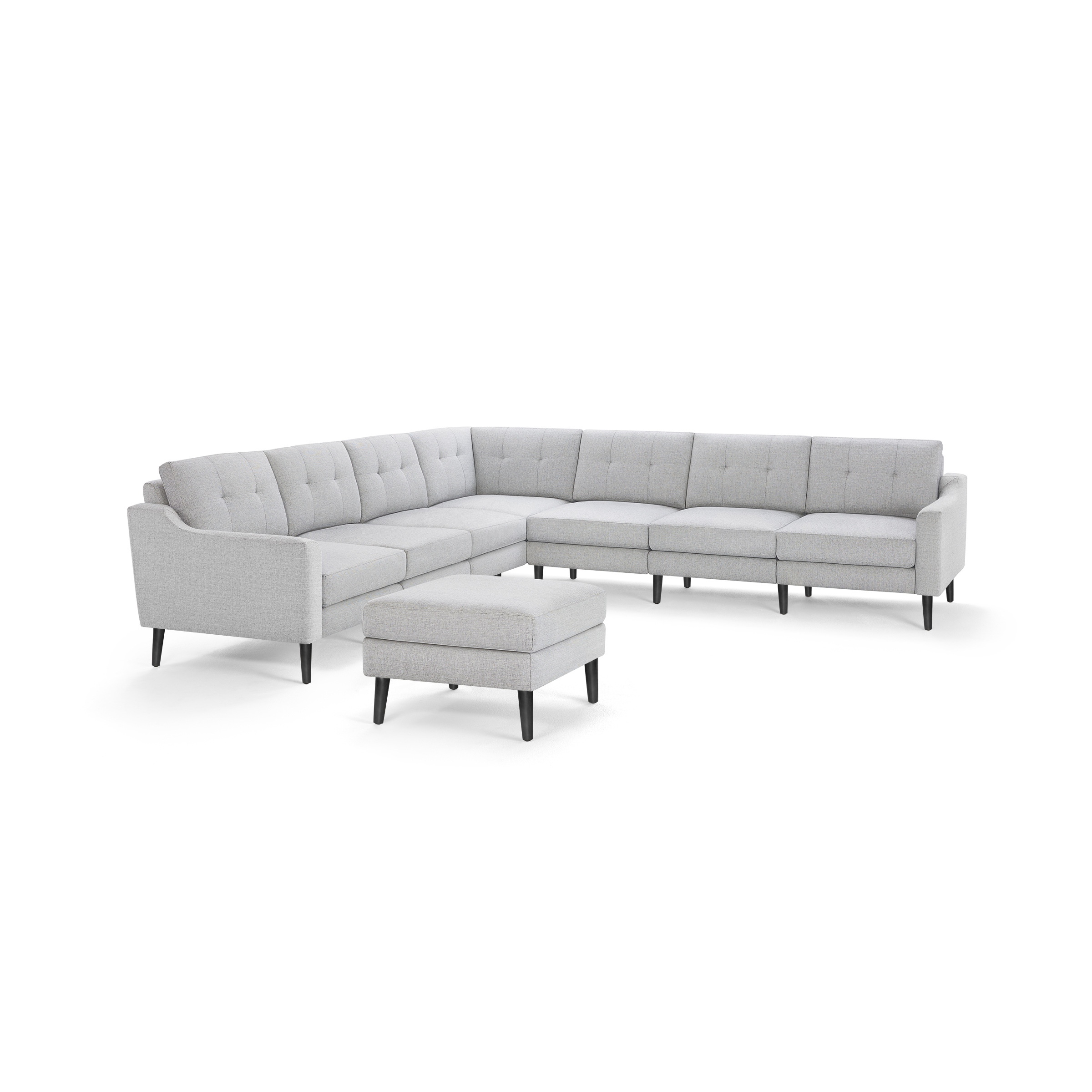 Light gray tufted fabric sectional sofa with matching ottoman, featuring black tapered legs and modern design.