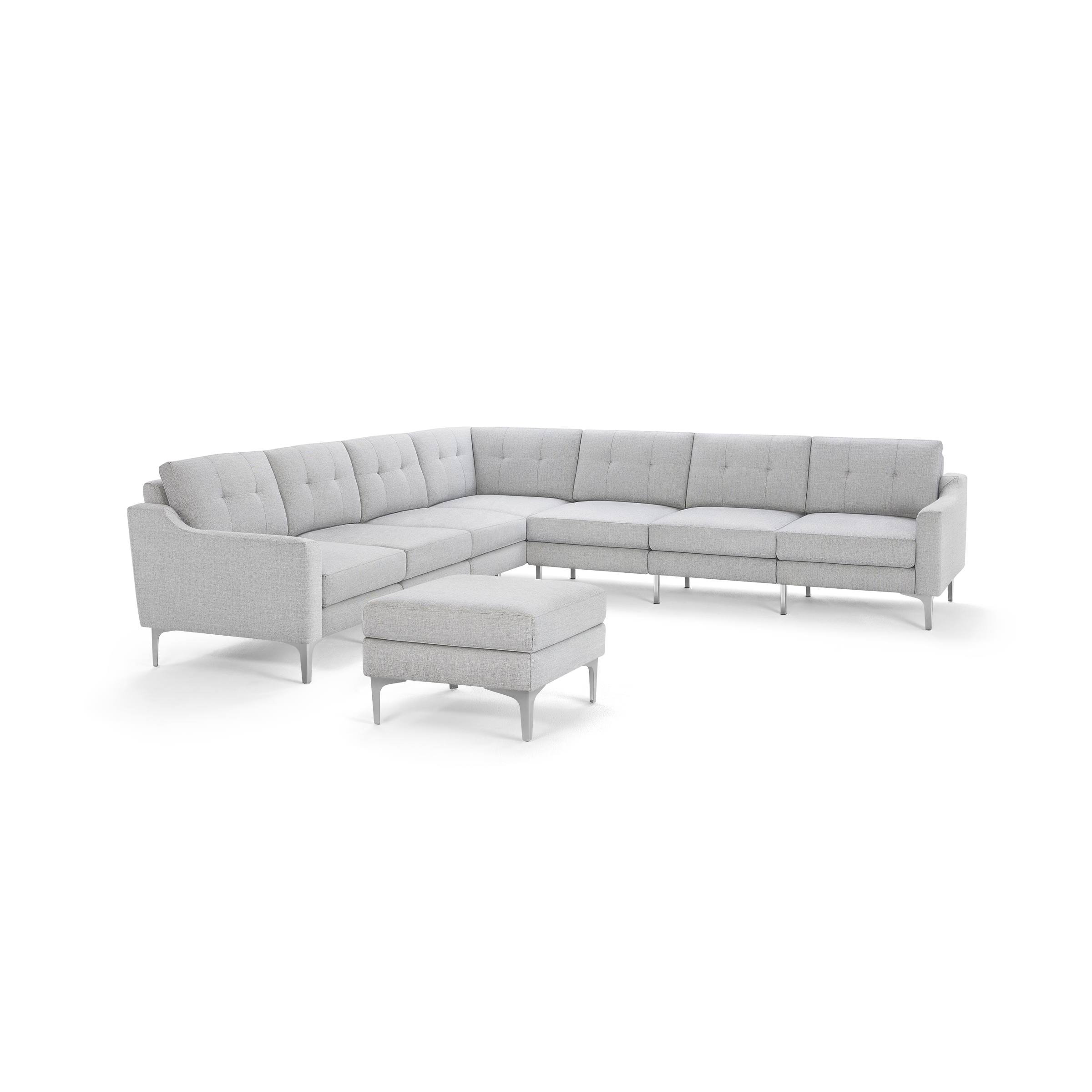 Light gray modern L-shaped sectional sofa with tufted cushions and matching cushioned ottoman on slim metal legs.