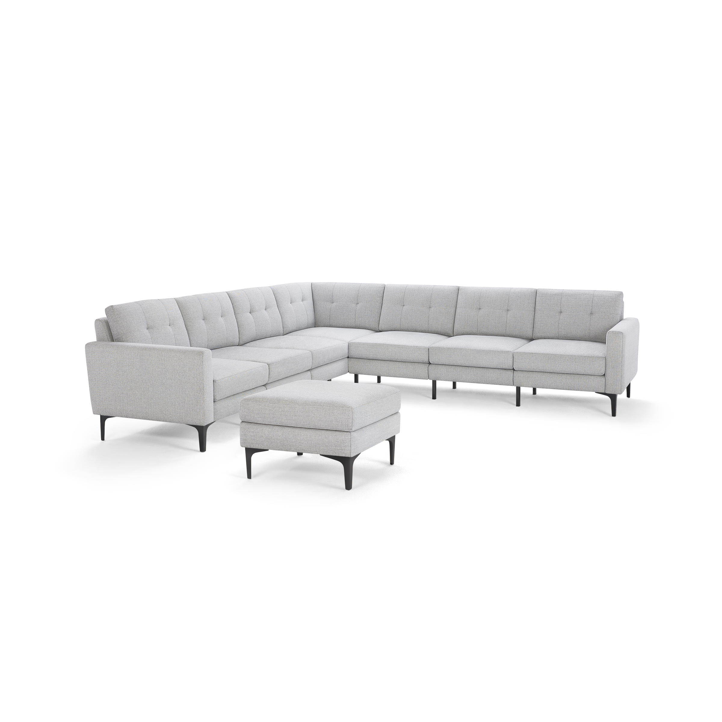 Light gray L-shaped sectional sofa with tufted back cushions and a matching ottoman, supported by black metal legs.