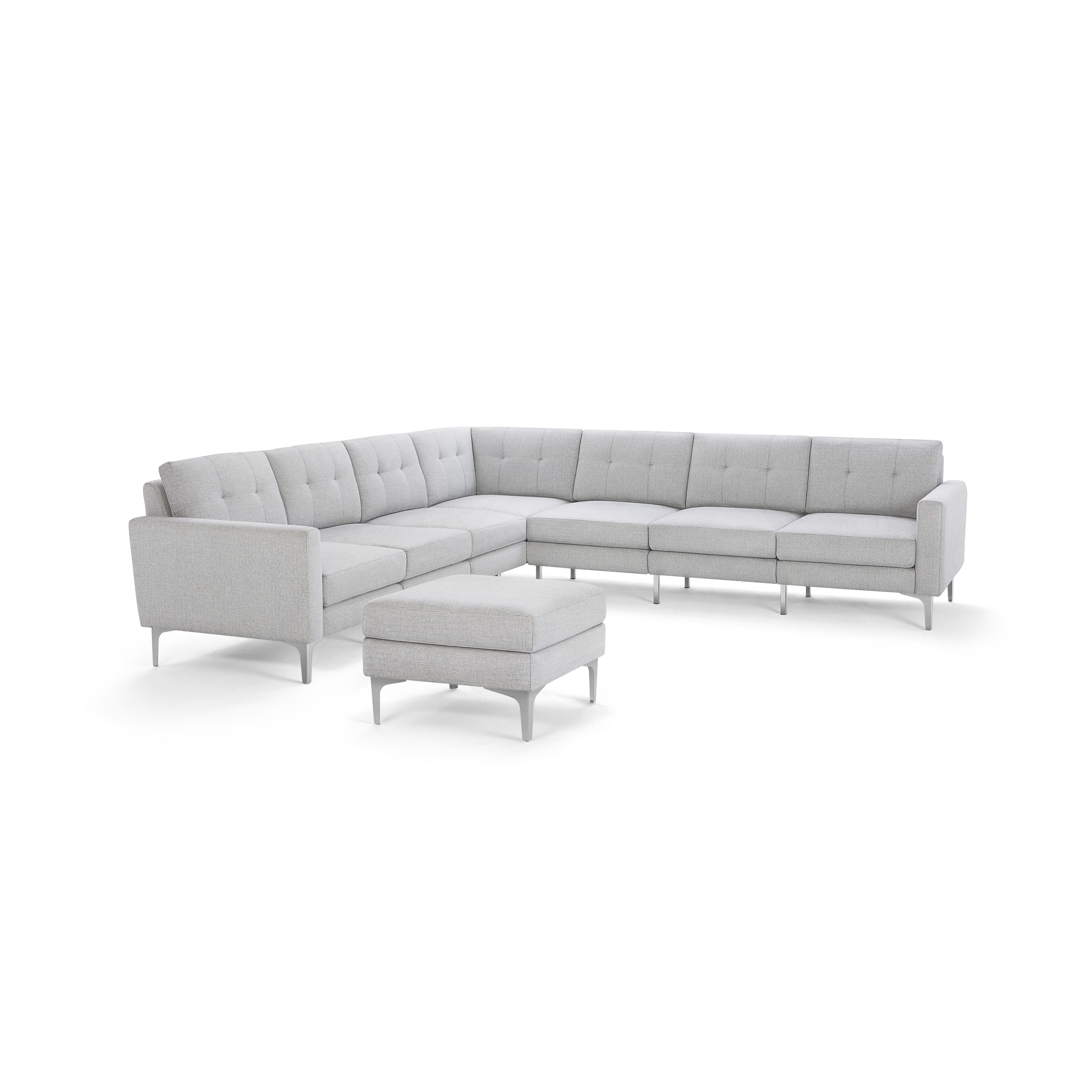 Light gray tufted fabric sectional sofa with metal legs and matching square ottoman.