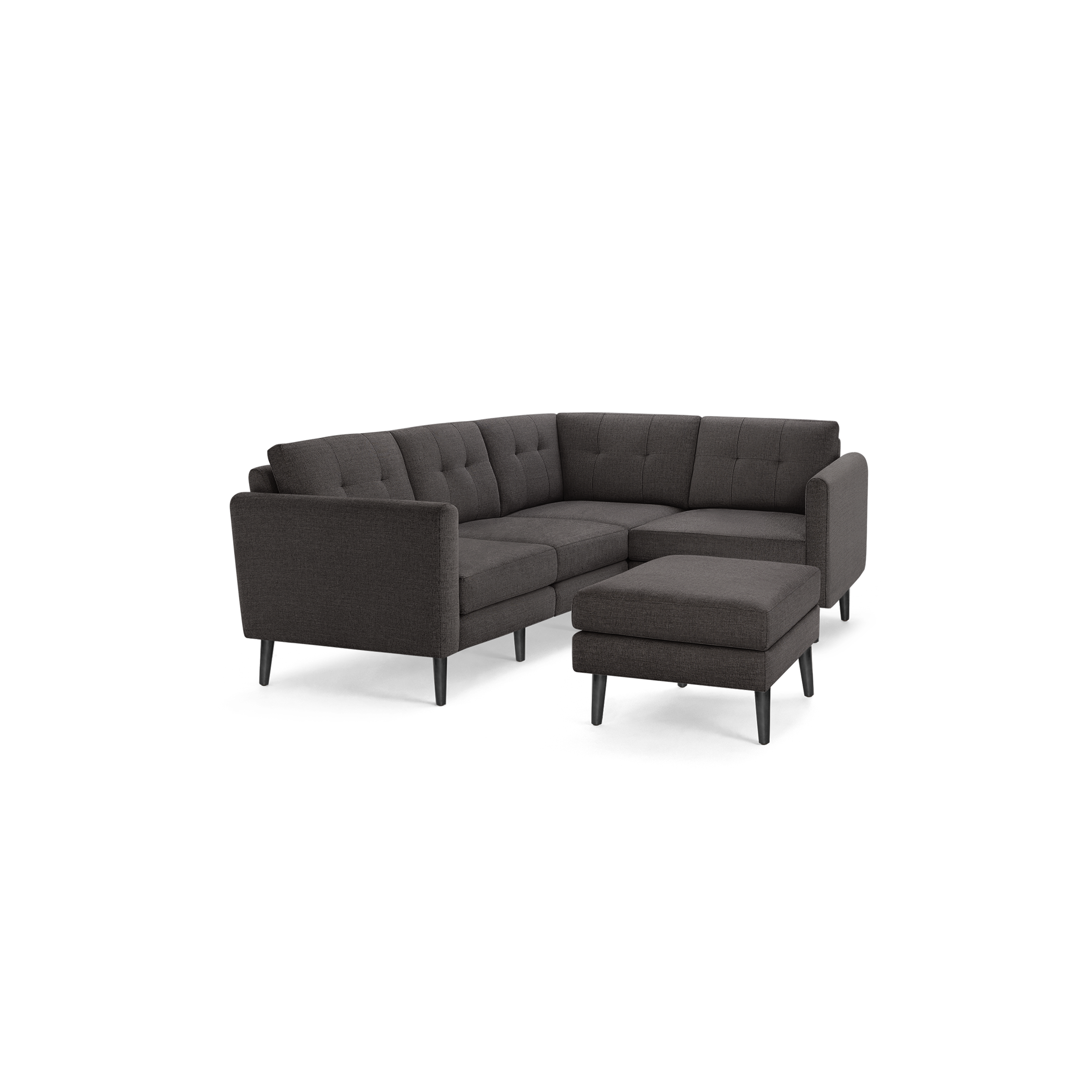 Dark gray L-shaped sectional sofa with tufted back cushions and matching ottoman, featuring slim black legs.