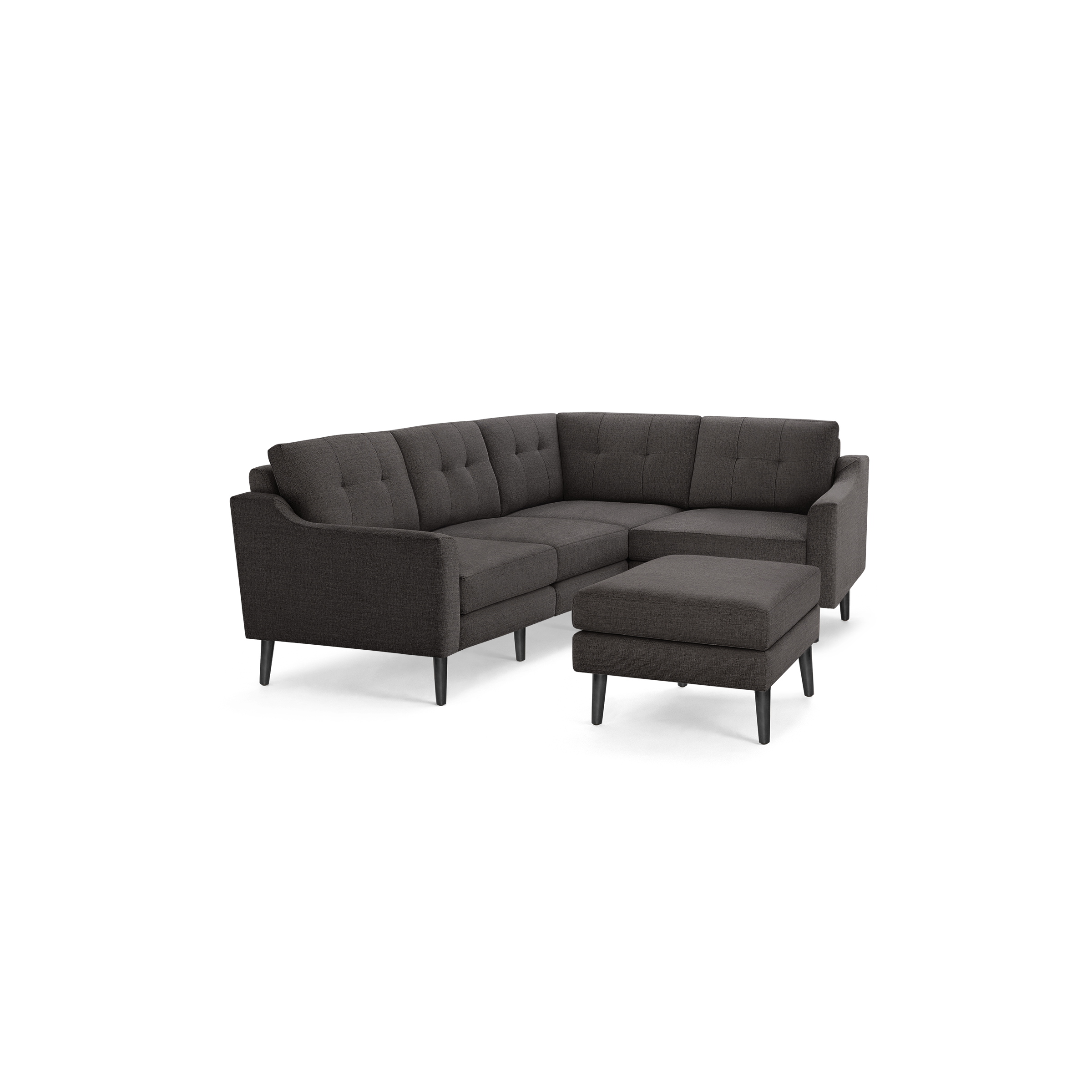 Dark gray fabric sectional sofa with tufted back cushions, angled armrests, black wooden legs, and matching ottoman.