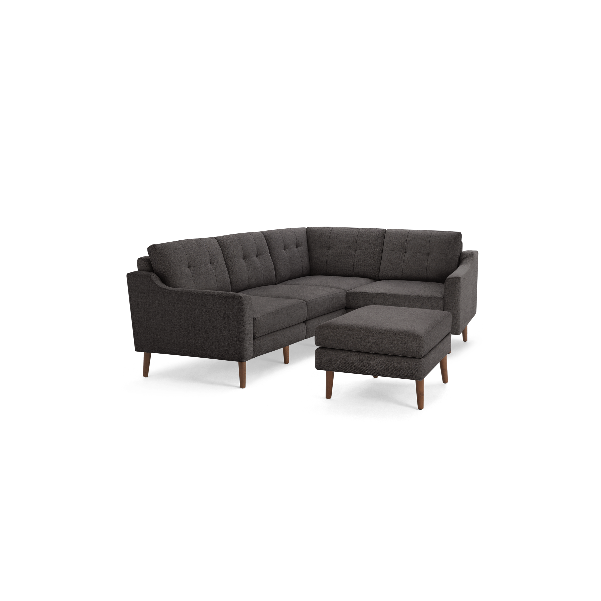 Dark gray upholstered L-shaped sectional sofa with tufted cushions and wooden legs, paired with matching ottoman.