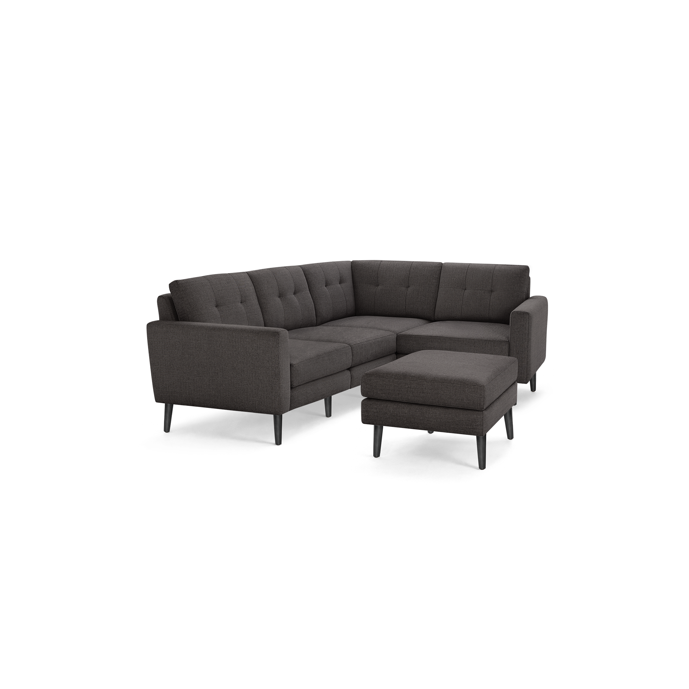 Dark gray L-shaped sectional sofa with tufted back cushions, matching ottoman, and slender black legs, modern and minimalist design.
