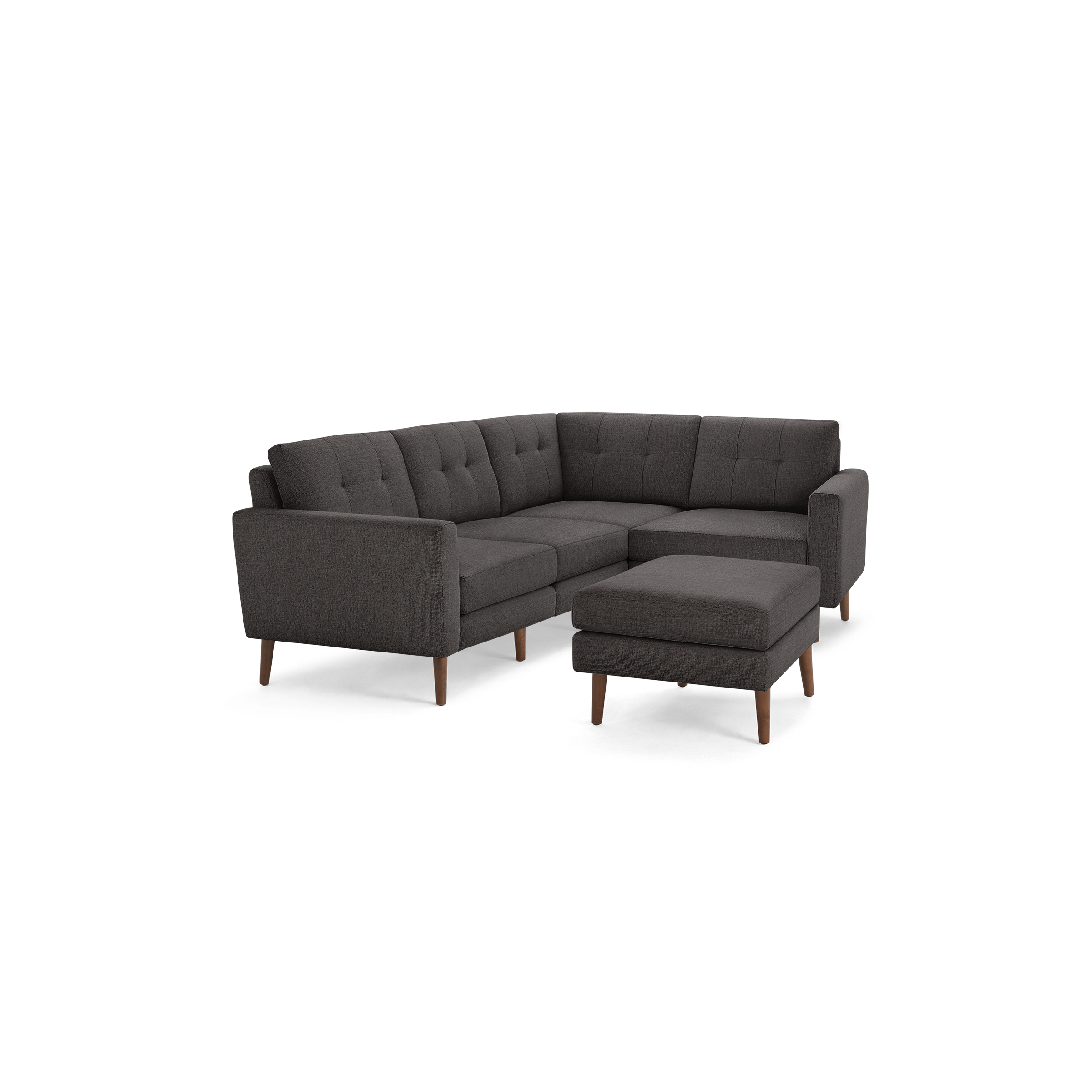 Dark gray fabric L-shaped sectional sofa with tufted cushions and wooden legs, including a matching ottoman.