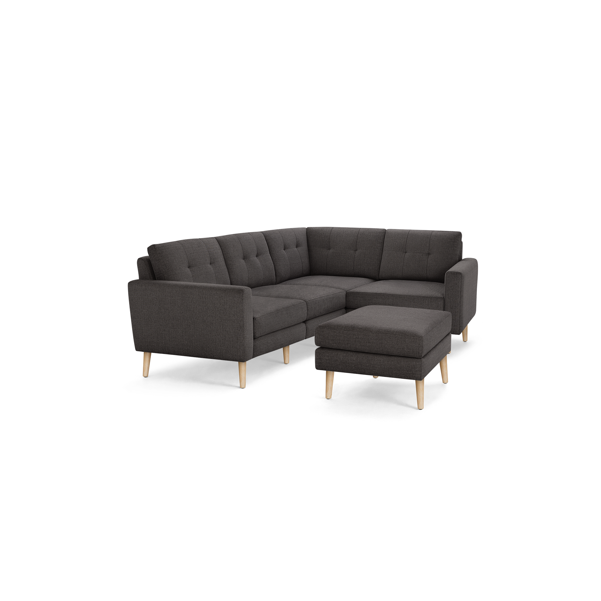 Dark gray L-shaped sectional sofa with tufted cushions and light wooden legs, including a matching ottoman.