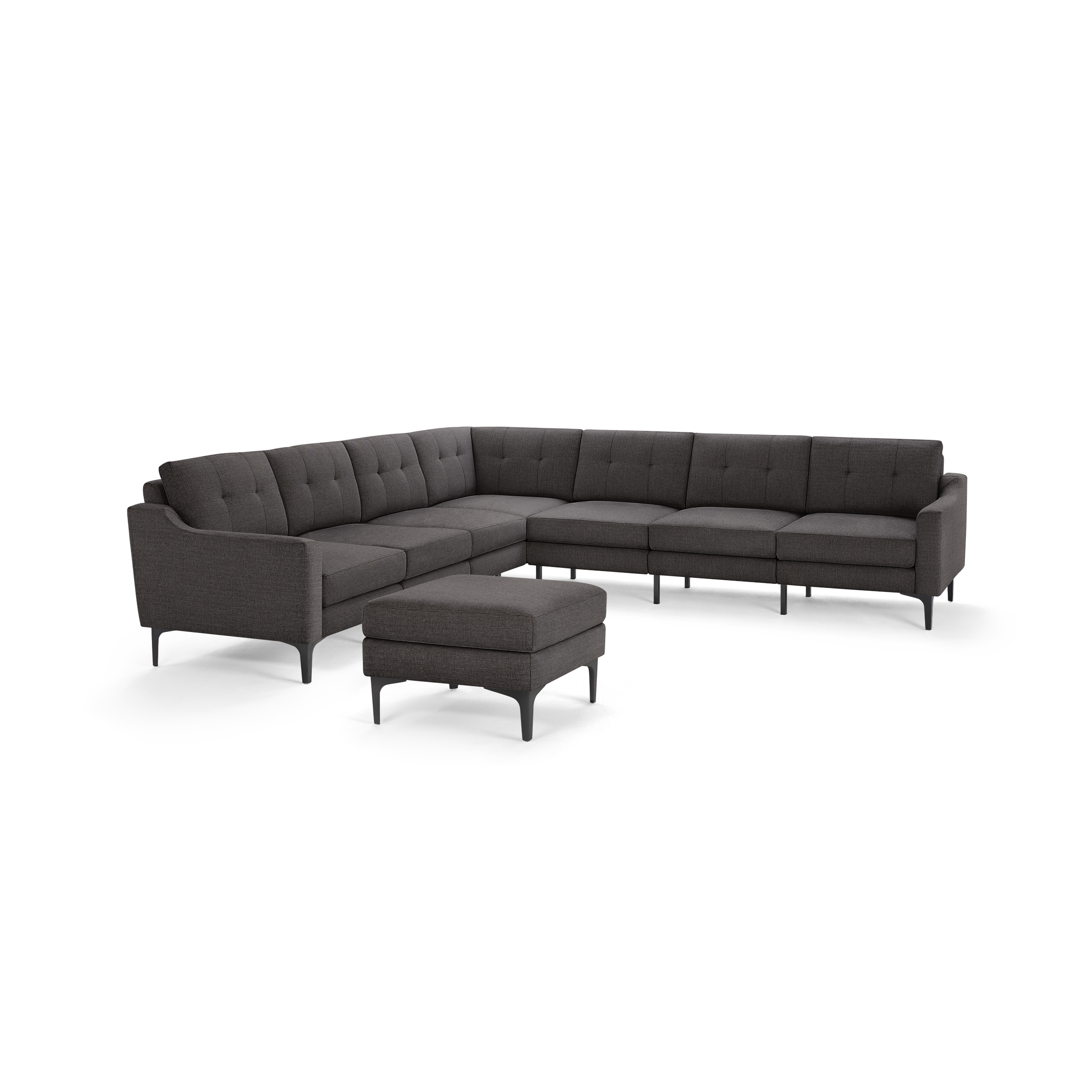 Dark gray L-shaped sectional sofa with button-tufted back cushions and matching ottoman on black legs.