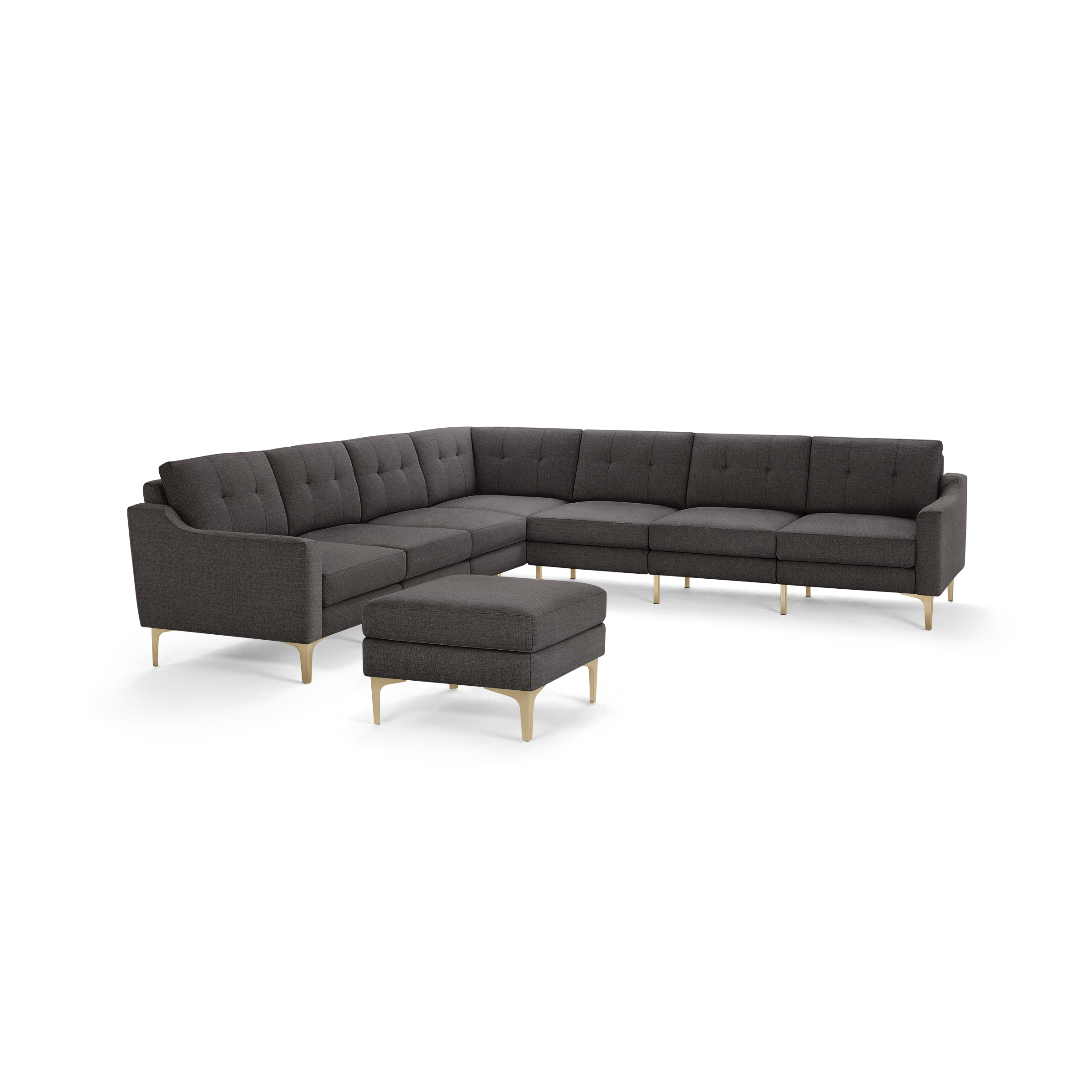 Dark gray L-shaped sectional sofa with tufted back cushions and matching ottoman, supported by light wooden legs.