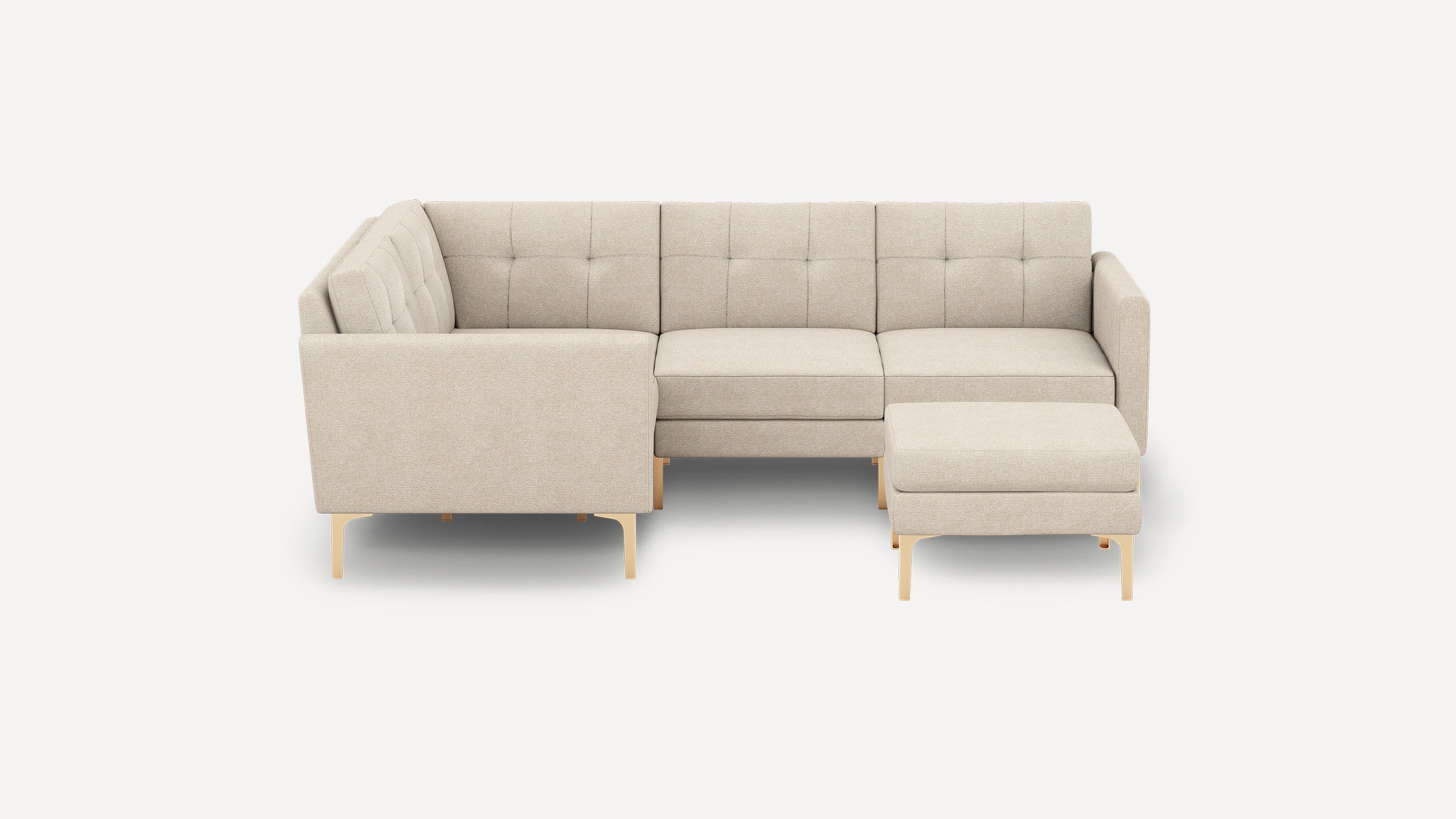 Beige L-shaped sectional sofa with tufted back cushions, wooden legs, and a matching ottoman on a plain white background.
