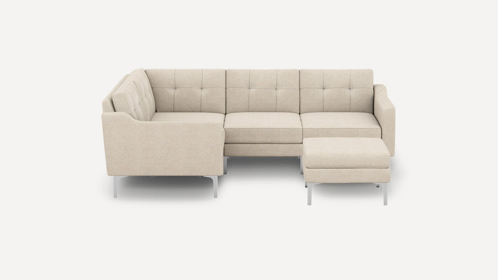Beige L-shaped sectional sofa with tufted back cushions, slim armrests, and metal legs, paired with matching ottoman.